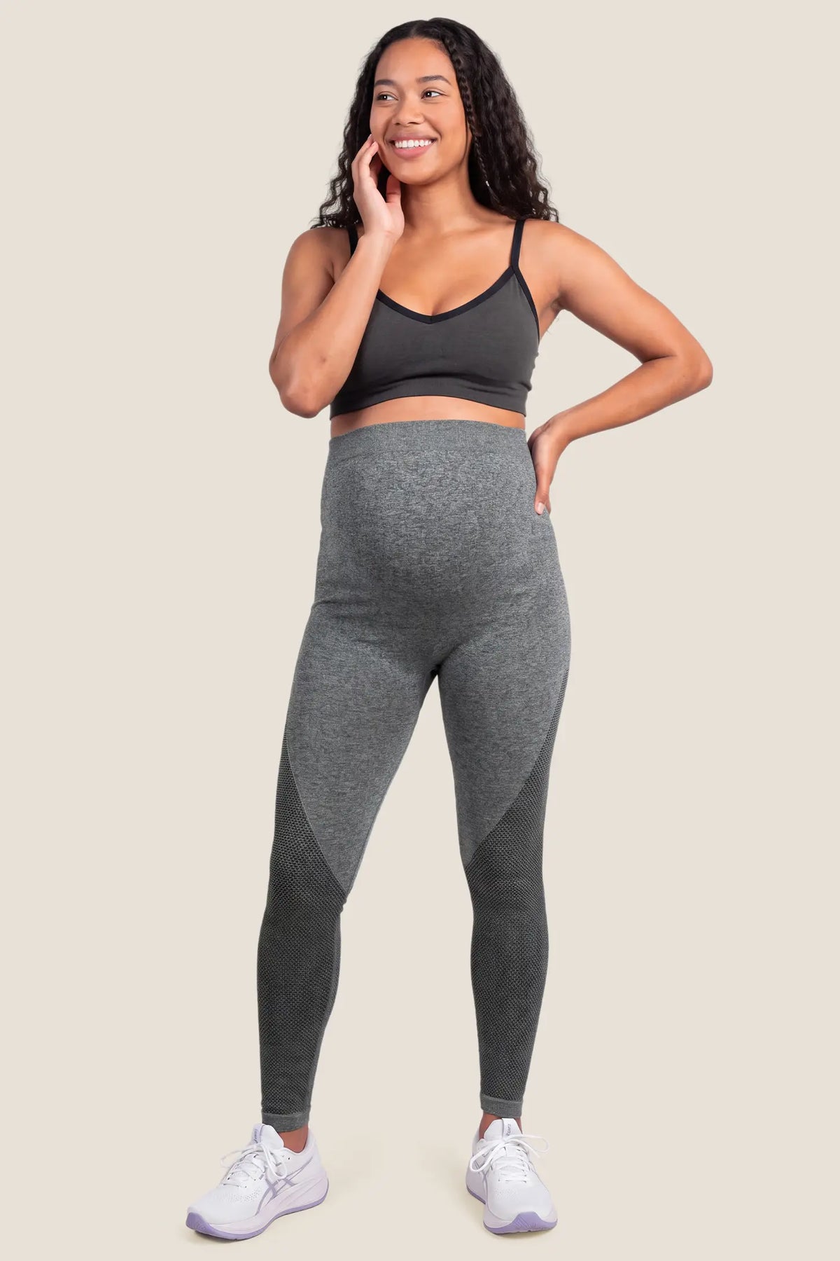 Seamless Over-the-Bump Maternity Leggings Seamless Over-the-Bump Maternity Leggings in Grey featuring breathable honeycomb knit panels, 360° over-the-bump support, and seamless anti-chafing comfort on a pregnant model, full-body front view.