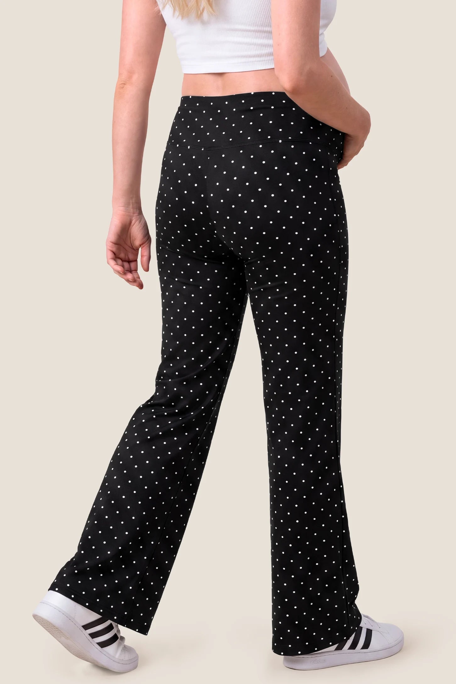 Seamless Polka Dot Maternity Flare Yoga Pants Seamless Polka Dot Maternity Flare Yoga Pants in Black Polka Dot featuring wide-leg flare design, high-waist band, soft stretch fabric, and full back coverage on a pregnant model, back view.