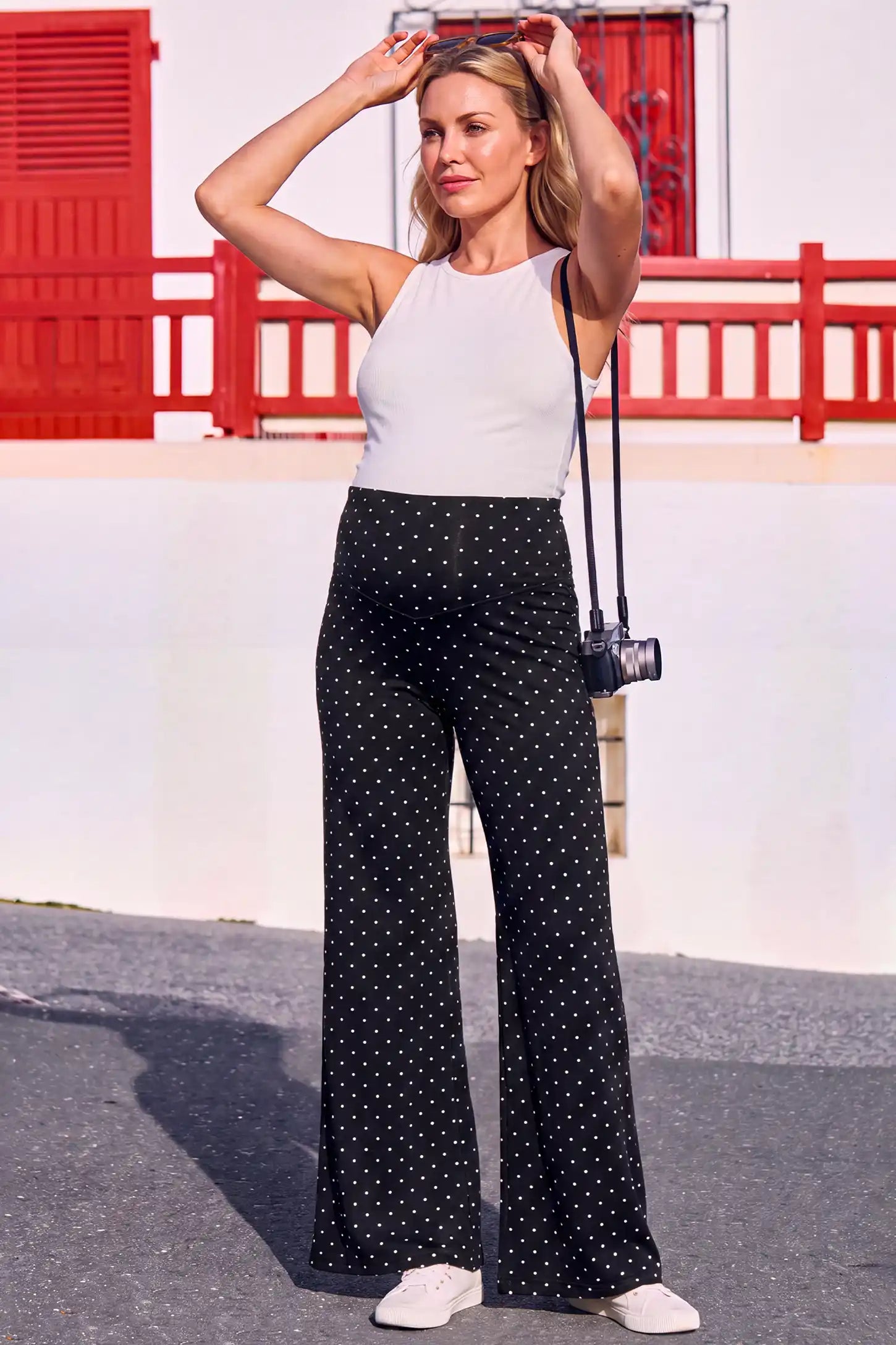 Seamless Polka Dot Maternity Flare Yoga Pants Seamless Polka Dot Maternity Flare Yoga Pants in Black Polka Dot featuring wide-leg silhouette, gentle bump support, and flattering relaxed fit on a pregnant model, outdoor lifestyle view.