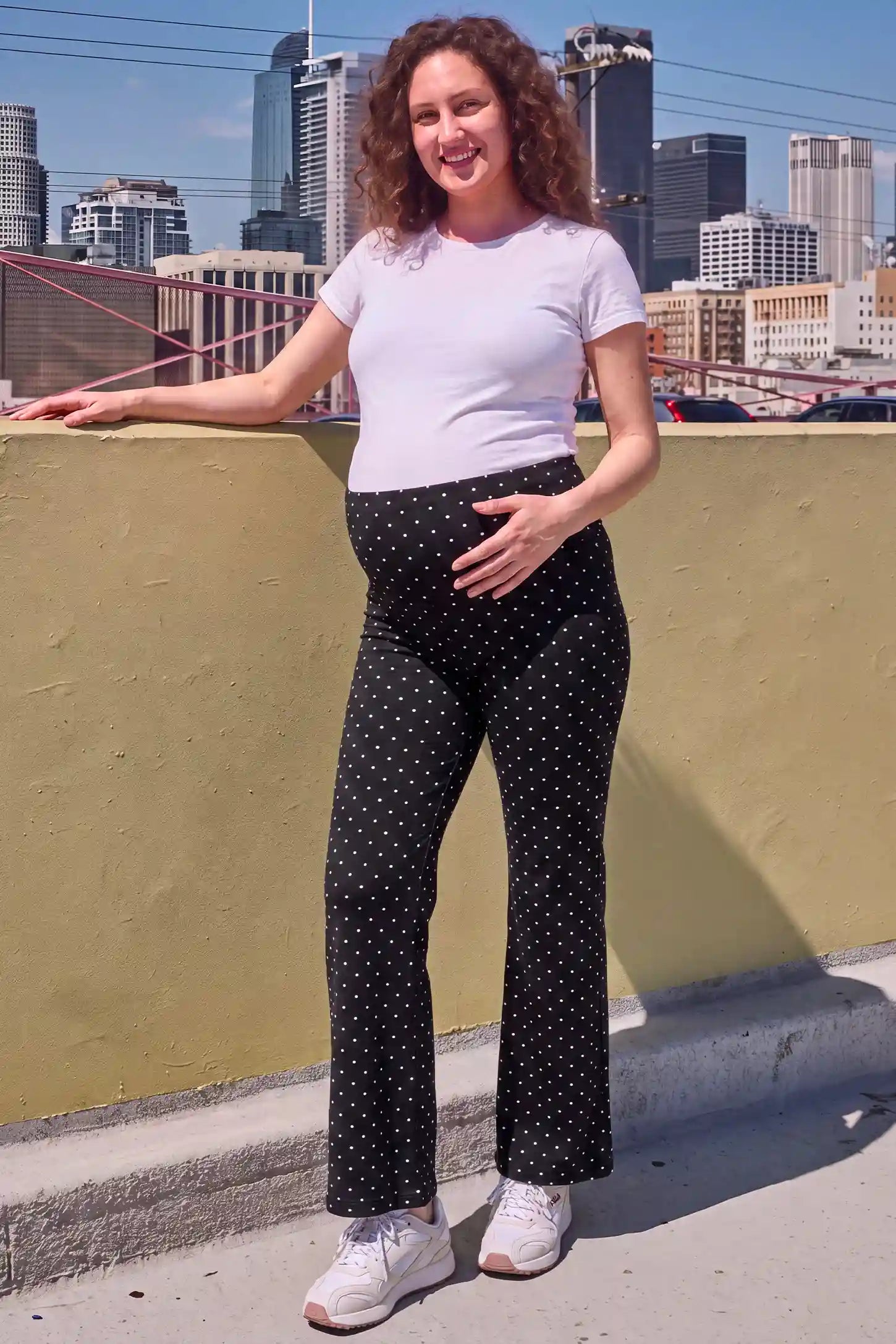 Seamless Polka Dot Maternity Flare Yoga Pants Seamless Polka Dot Maternity Flare Yoga Pants in Black Polka Dot featuring comfortable elastic waistband, soft stretch material, and activewear style on a pregnant model, urban outdoor view.