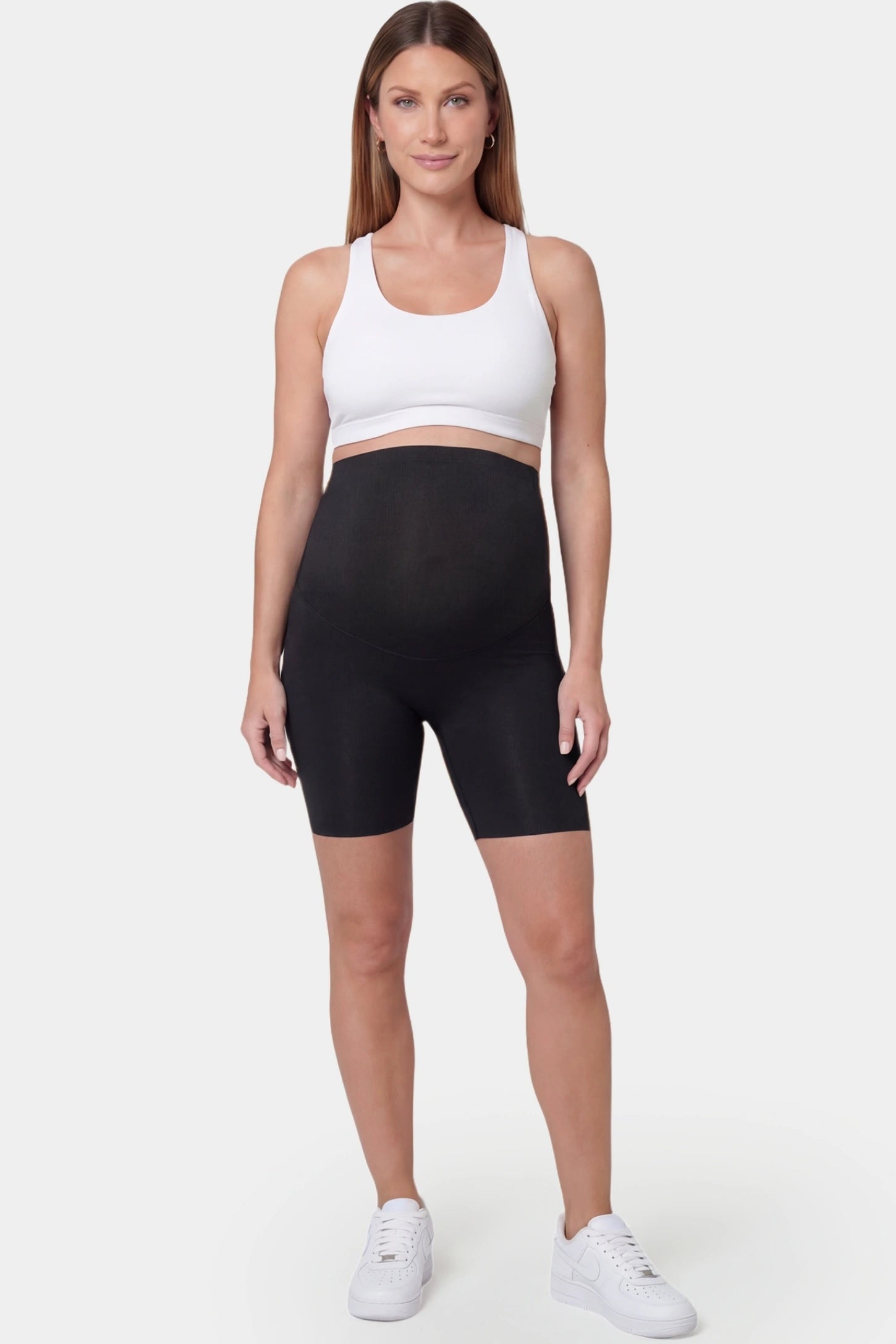 Seamless Belly Support Mid-Thigh Shaping Maternity Shorts Seamless belly support mid-thigh shaping maternity shorts in black with sculpting fit, full body on pregnant model