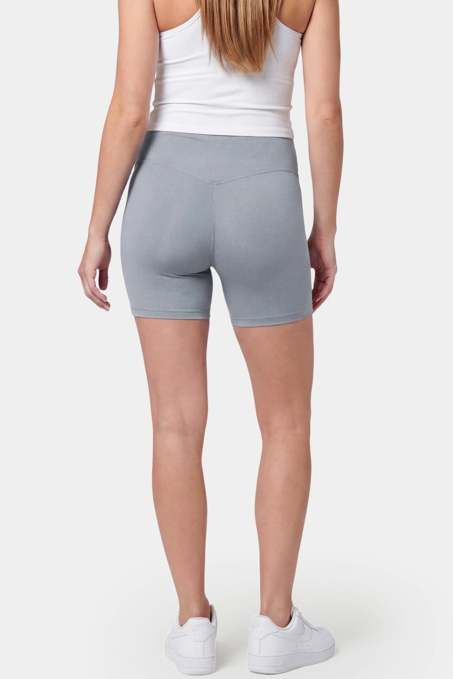 Seamless Belly Support Mid-Thigh Shaping Maternity Shorts Seamless belly support mid-thigh shaping maternity shorts in gray with smoothing rear design, back view on pregnant model