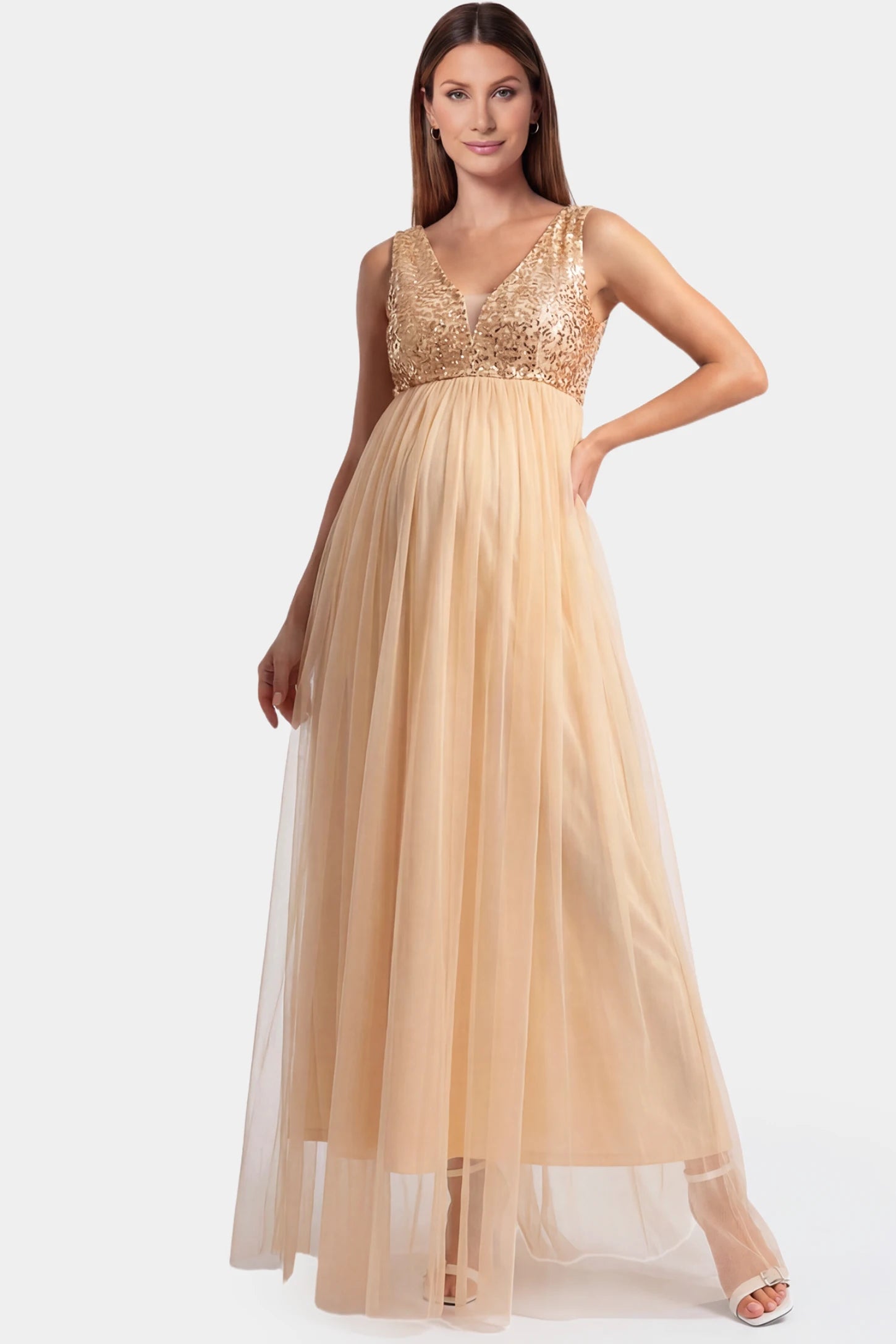 Sequin bodice sleeveless maxi maternity dress in gold featuring mesh skirt shown in full body front view on a pregnant model