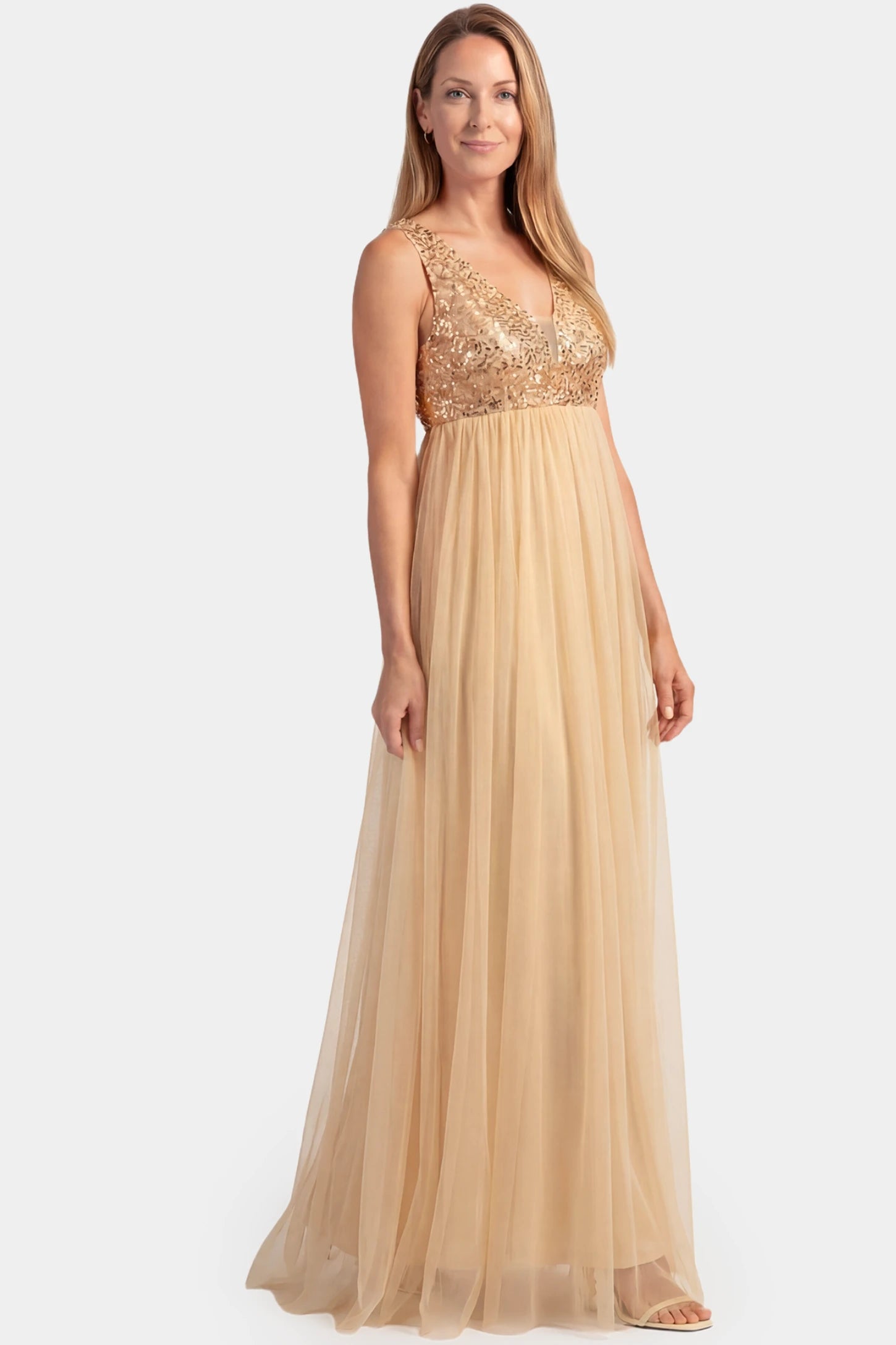 Sequin Bodice Sleeveless Maxi Maternity Dress Sequin bodice sleeveless maxi maternity dress in gold featuring mesh skirt shown in full body front view on a postpartum model