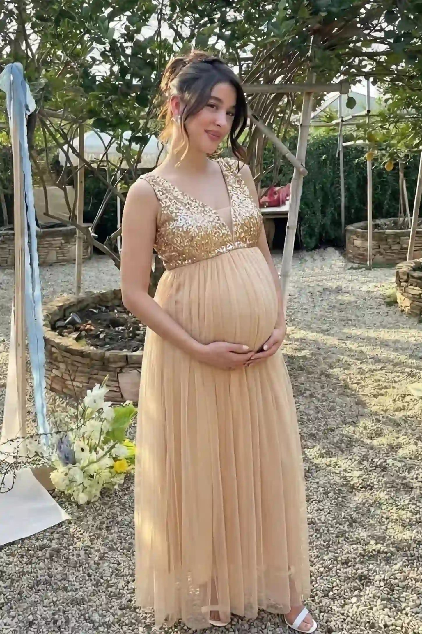 Sequin Bodice Sleeveless Maxi Maternity Dress Sequin bodice sleeveless maxi maternity dress in gold featuring mesh skirt shown in full body front view on a UGC model