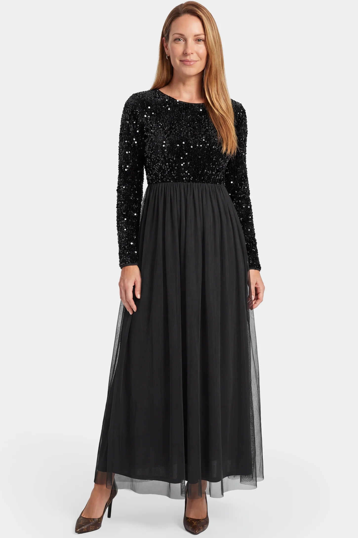 Sequined Mesh Long-Sleeve Maxi Maternity Gown Sequined mesh long sleeve maxi maternity gown in black featuring flowing mesh skirt in full body front view on a postpartum model