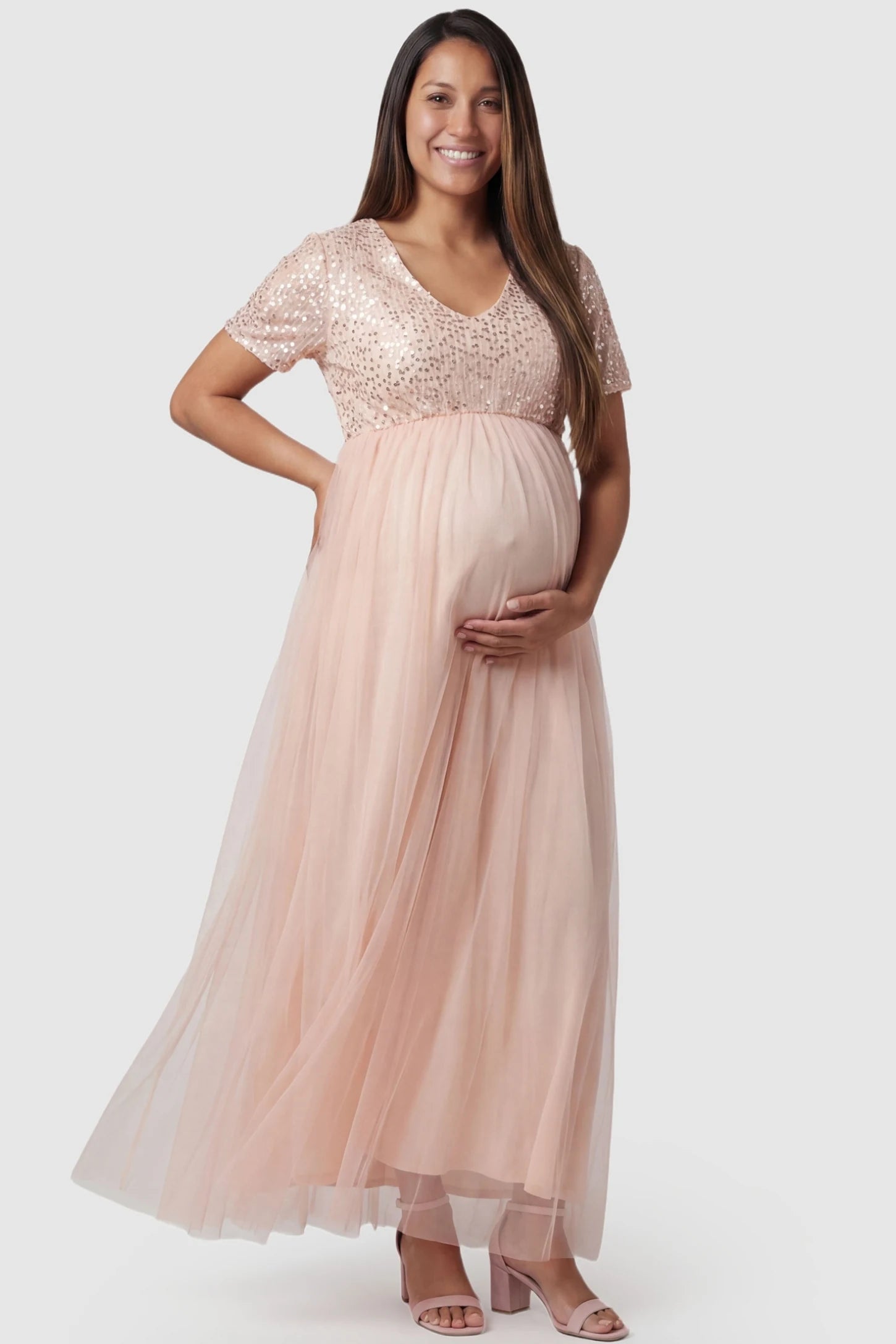 Sequin Ruffle Sleeve Maternity Photoshoot Dress in Pink featuring a sparkly bodice on a pregnant model, front view.