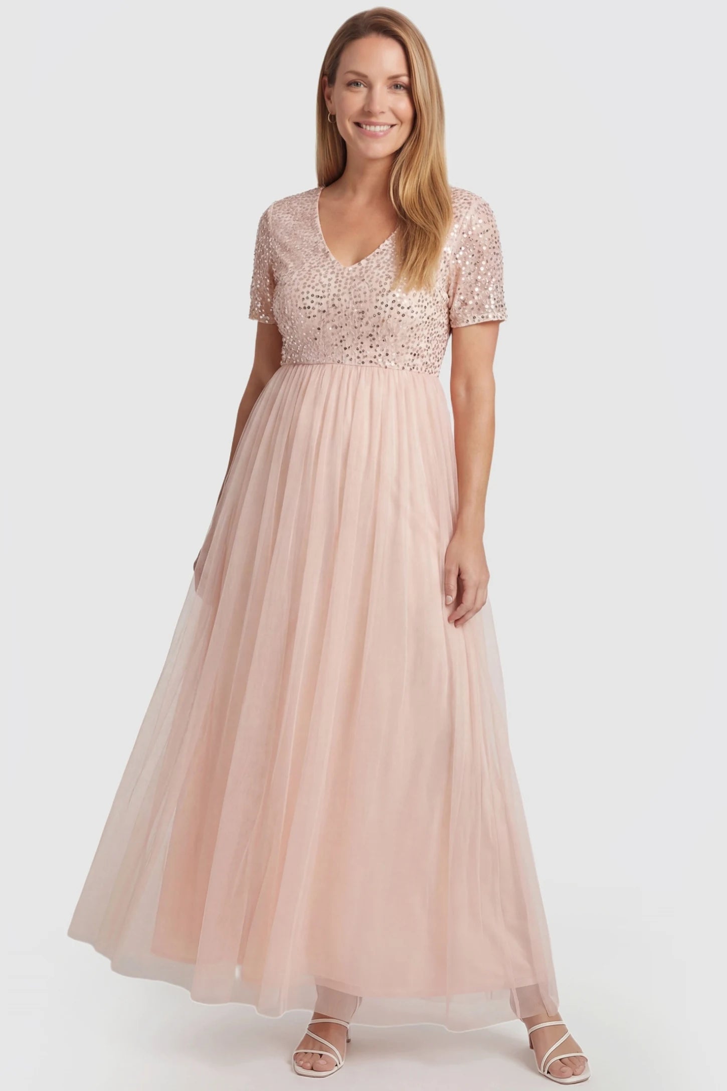 Sequin Ruffle Sleeve Maternity Photoshoot Dress Sequin Ruffle Sleeve Maternity Photoshoot Dress in Pink featuring a V-neckline on a non-pregnant model, front view.