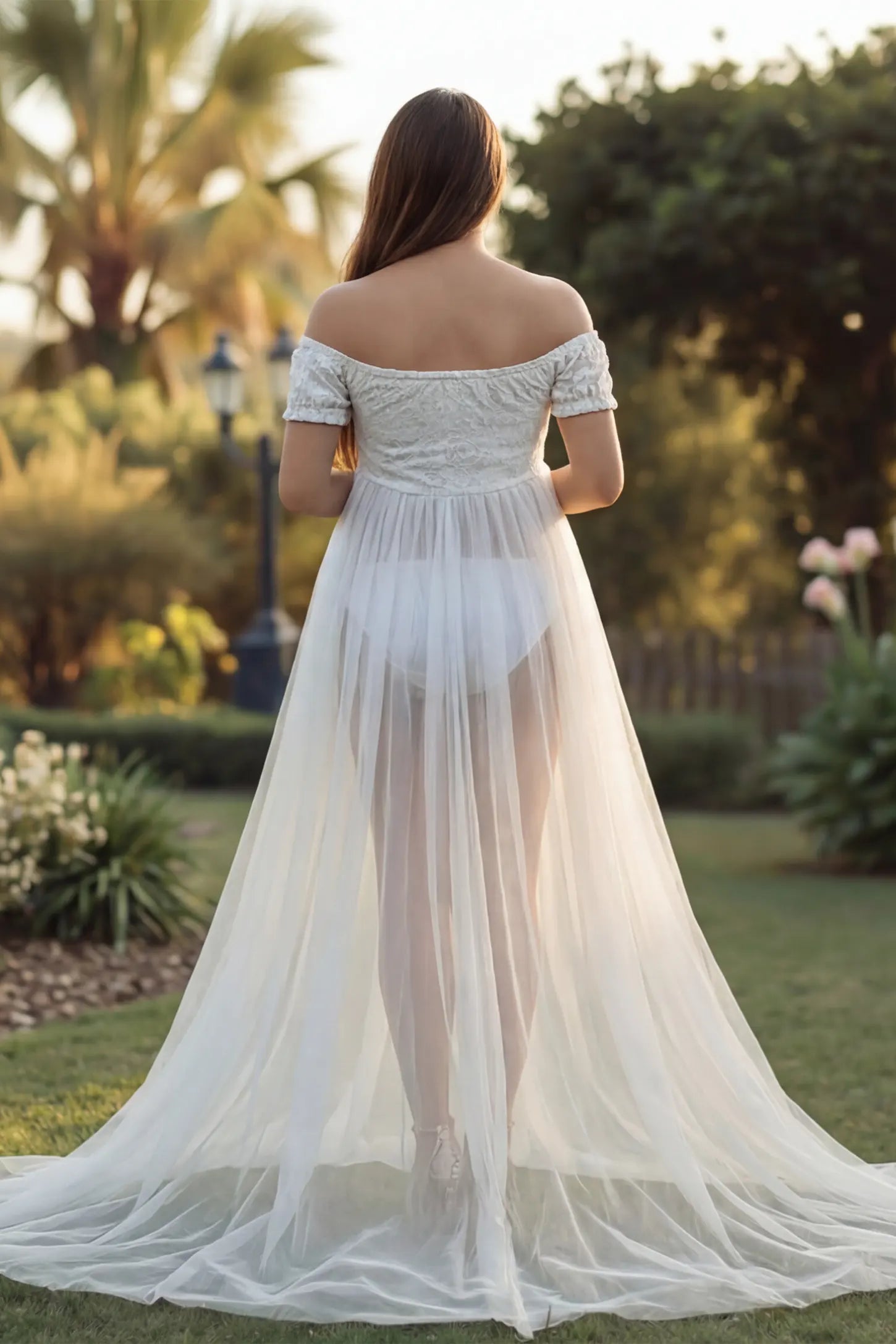 Lace Sheer Overlay Off-Shoulder Maternity Photoshoot Gown Lace Sheer Overlay Off Shoulder Maternity Photoshoot Gown in white featuring sweetheart neckline and flowing sheer skirt on a pregnant model.