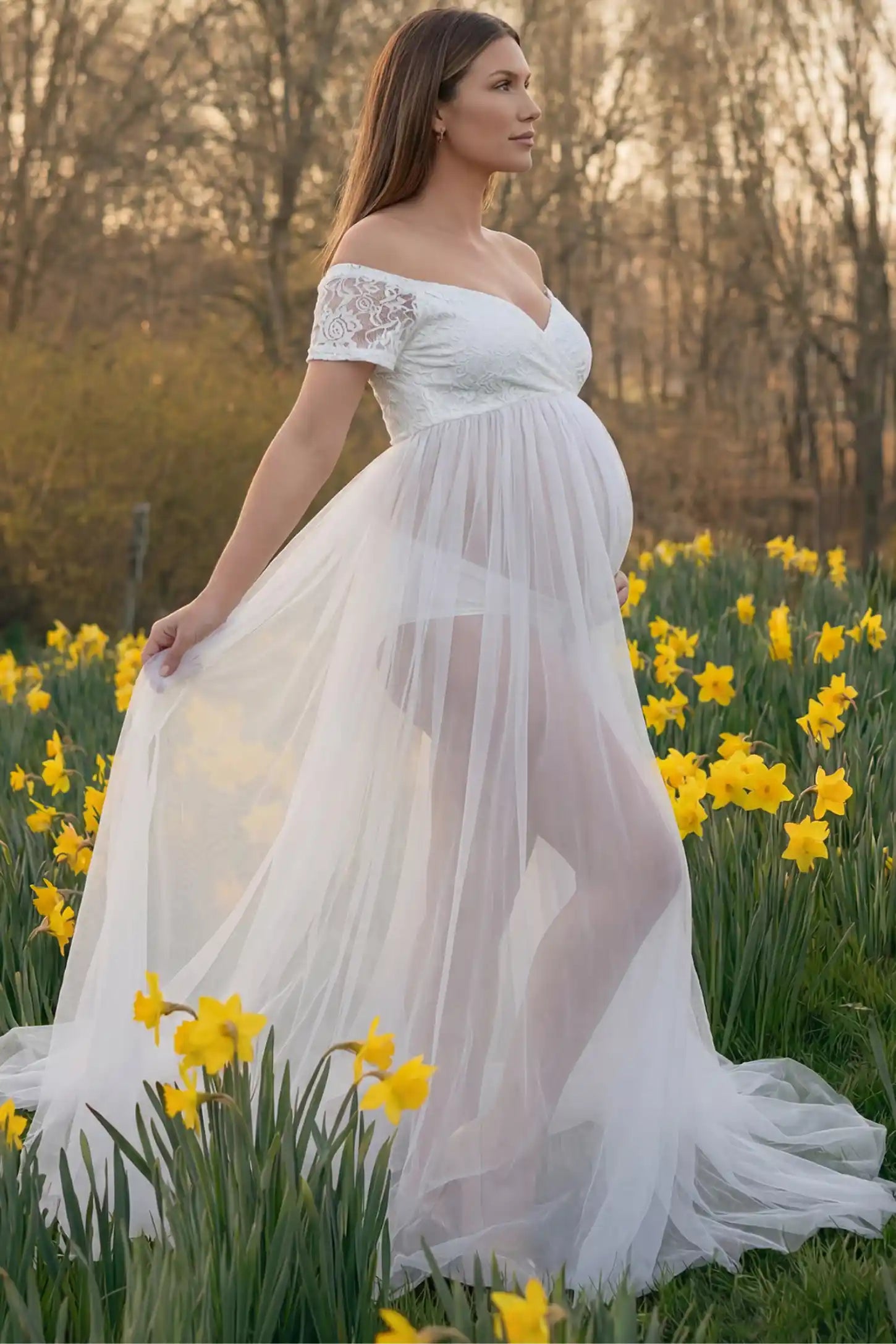 Lace Sheer Overlay Off-Shoulder Maternity Photoshoot Dress Lace Sheer Overlay Off Shoulder Maternity Photoshoot Gown in white featuring sweetheart neckline and flowing sheer skirt on a side view pregnant model.