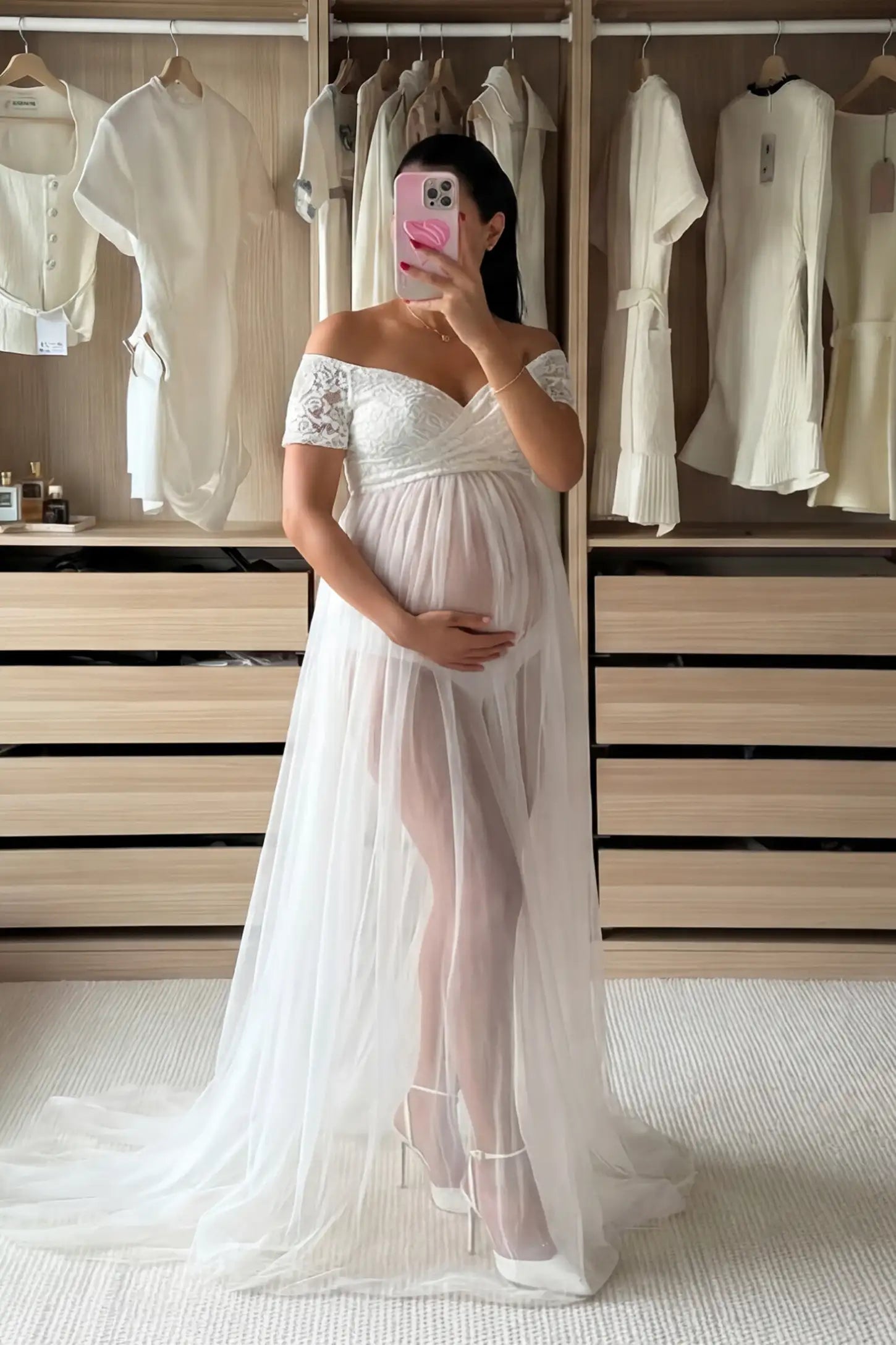 Lace Sheer Overlay Off-Shoulder Maternity Photoshoot Gown Lace Sheer Overlay Off Shoulder Maternity Photoshoot Gown in white featuring sweetheart neckline and flowing sheer skirt on a pregnant model.