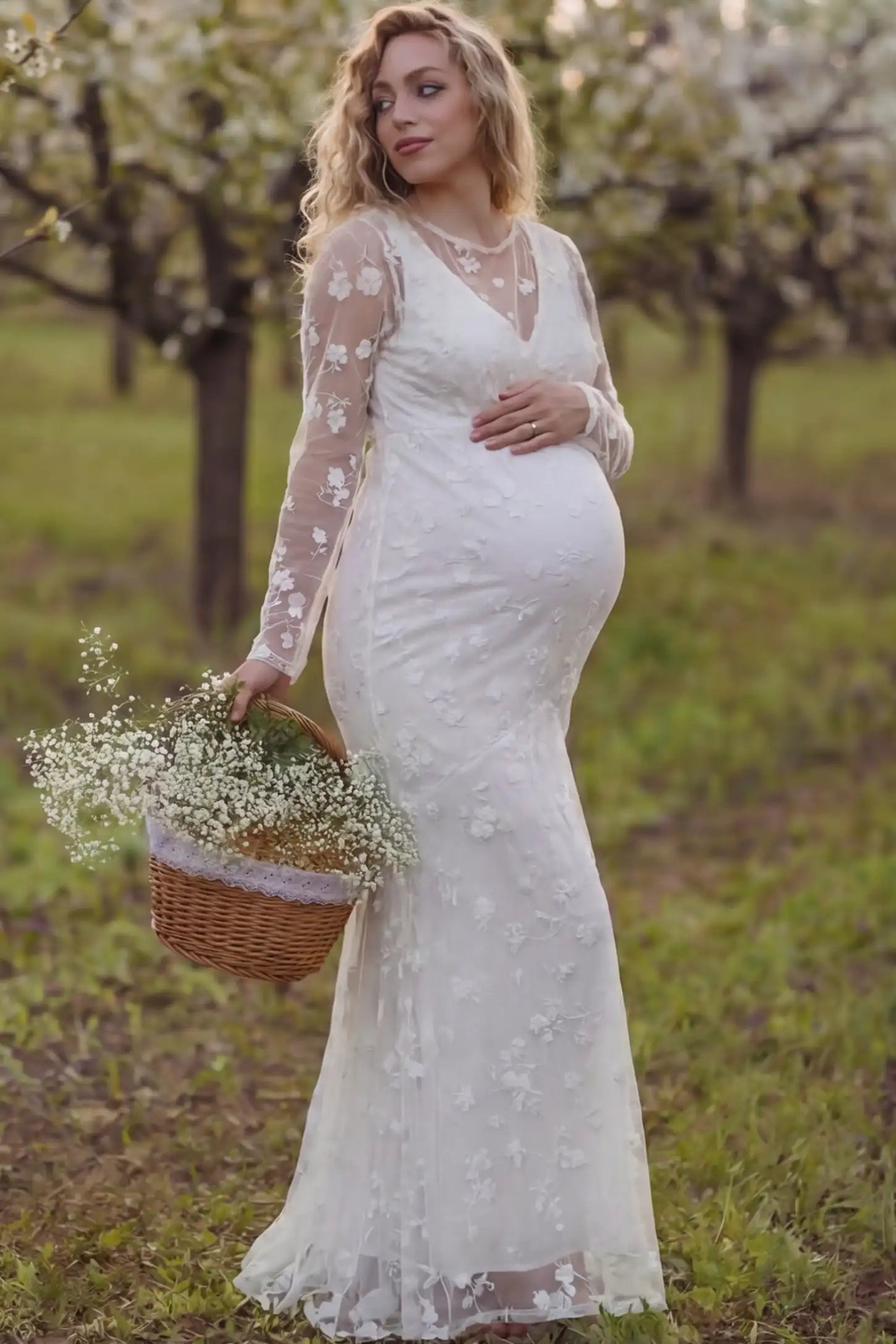 Lace Long Sheer Sleeve Bridal Maternity Gown in white featuring floral embroidery and long sheer sleeves on a pregnant model during photoshoot.