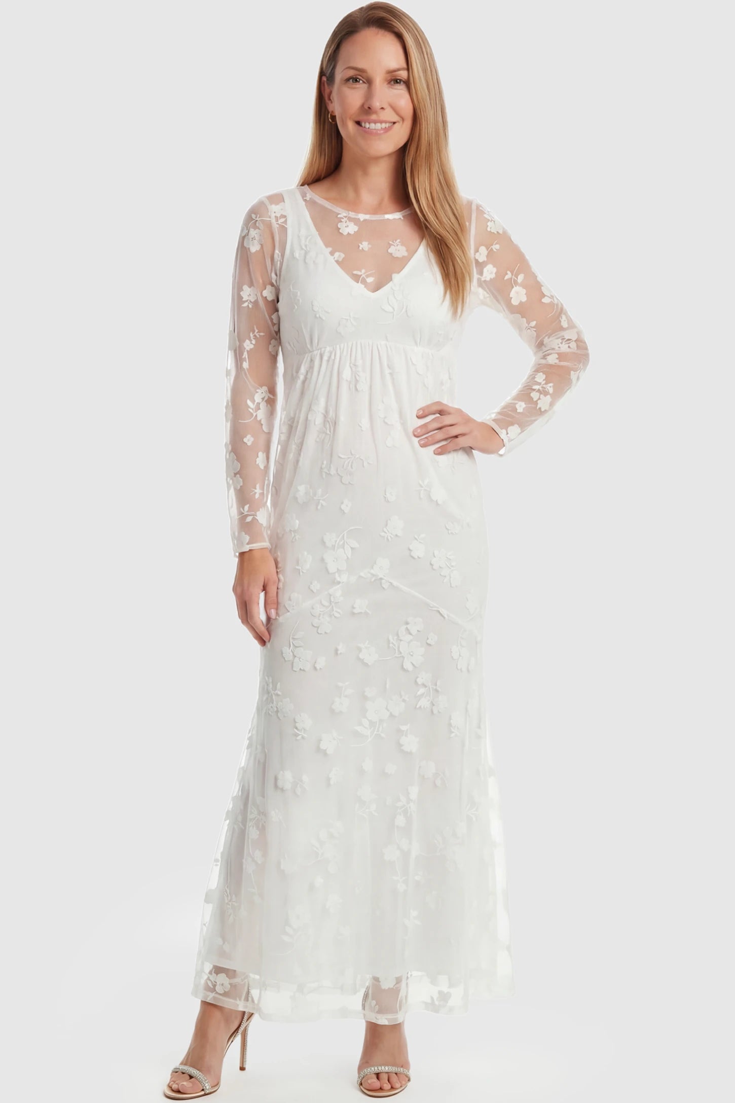 Lace Long Sheer Sleeve Bridal Maternity Gown Lace Long Sheer Sleeve Bridal Maternity Gown in white featuring floral embroidery and long sheer sleeves on a postpartum model front view