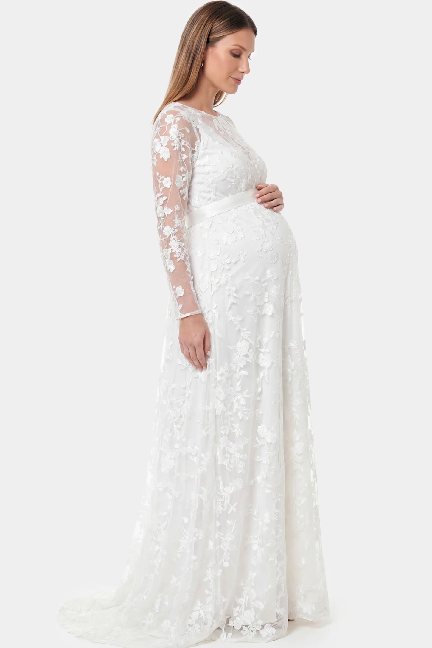 Lace Long Sheer Sleeve Bridal Maternity Gown in white featuring back train and sheer lace sleeves on a pregnant model.