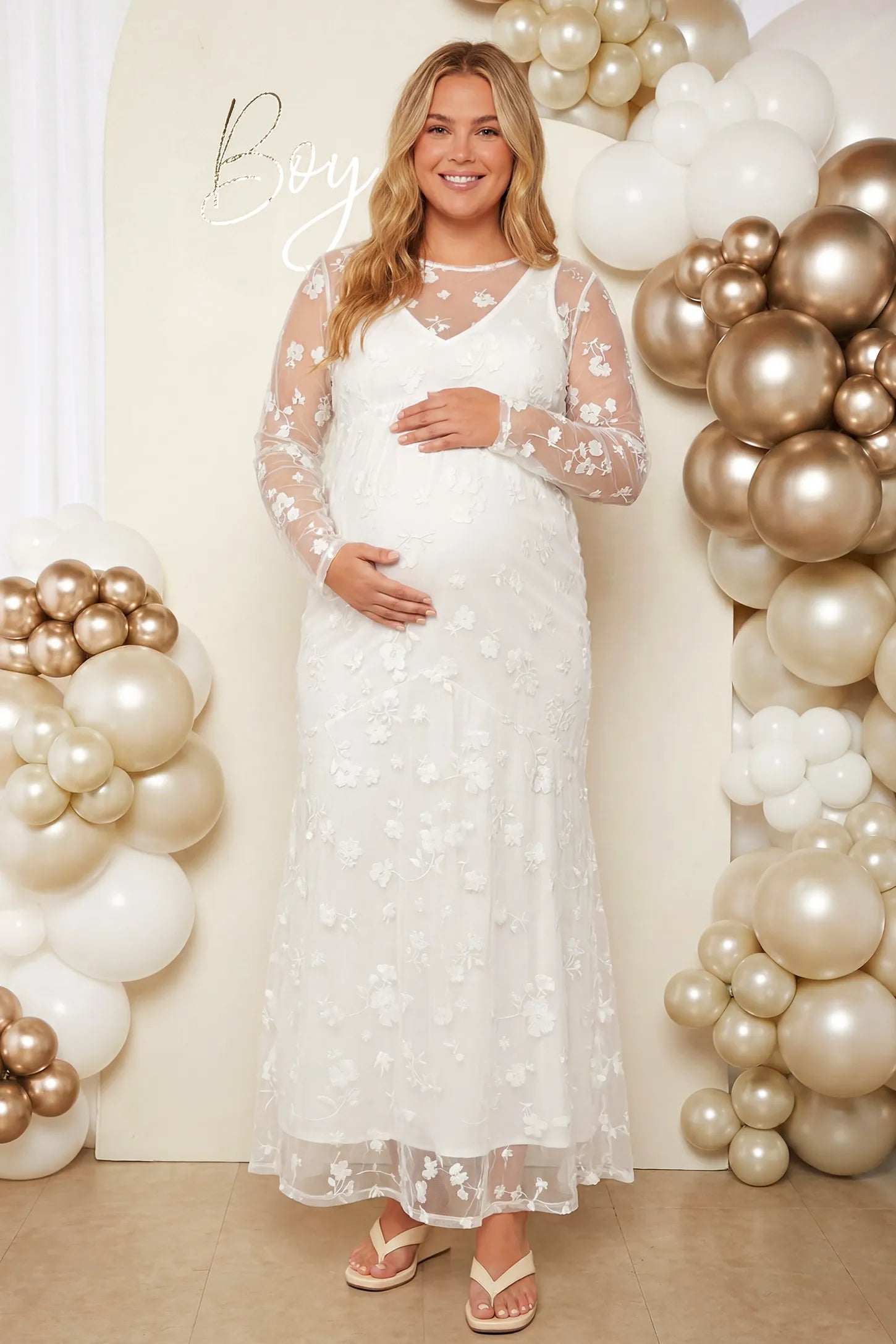 Lace Long Sheer Sleeve Bridal Maternity Gown in white featuring floral embroidery and long sheer sleeves on a pregnant model during baby shower.