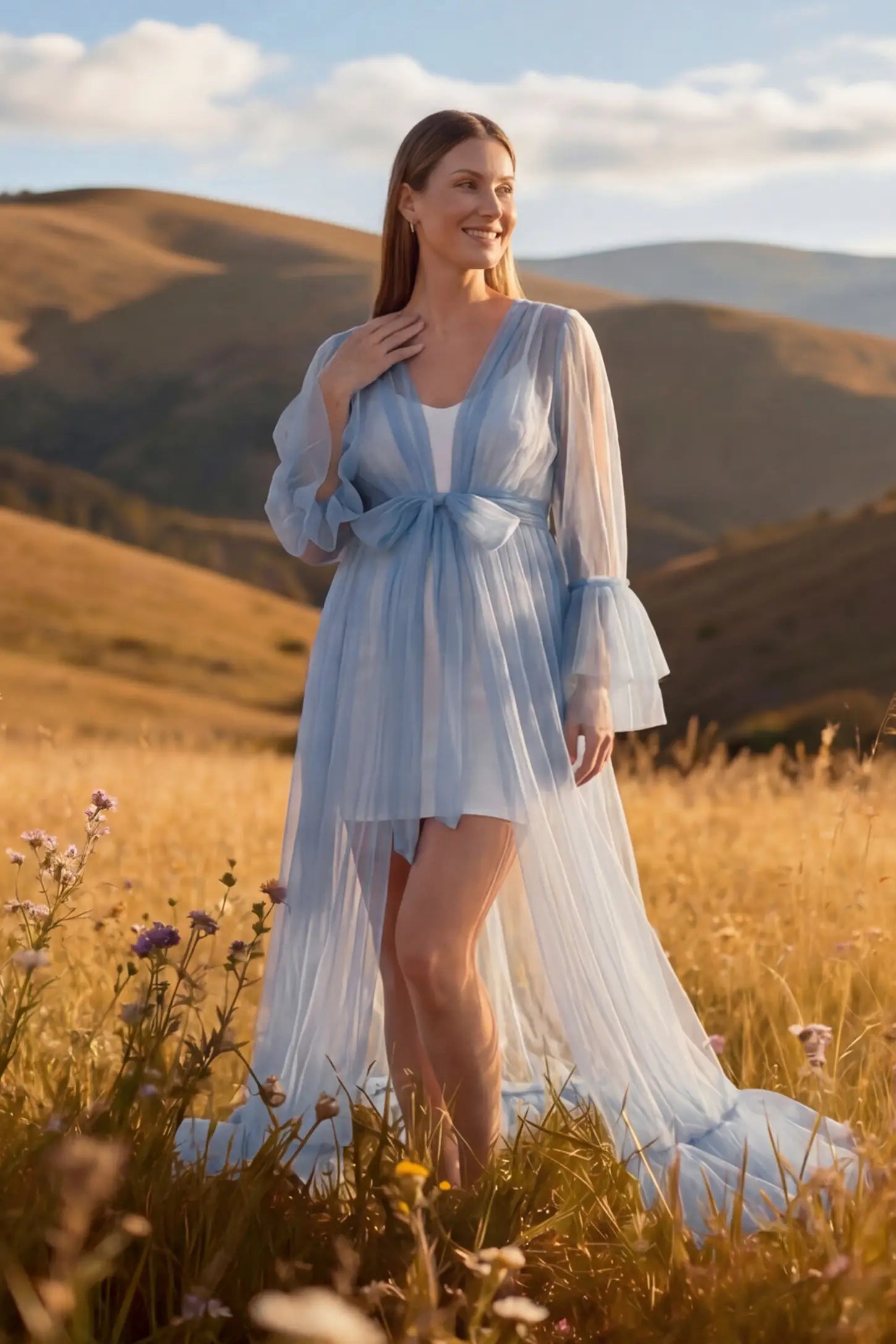 Sheer Tulle Deep V-Neck Tiered Maternity Maxi Gown Sheer tulle deep V-neck tiered maternity maxi gown in Blue with deep V-neckline and statement bow waist, front view on pregnant model