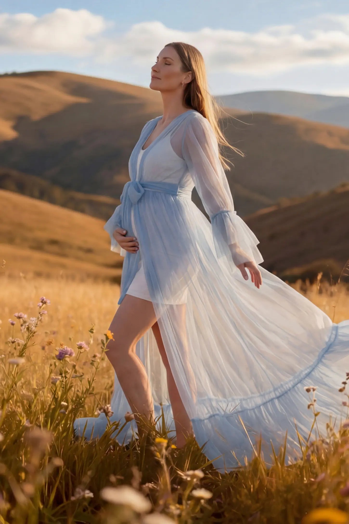 Sheer Tulle Deep V-Neck Tiered Maternity Maxi Gown Sheer tulle deep V-neck tiered maternity maxi gown in Blue with bump-enhancing layered tulle design, side view on pregnant model
