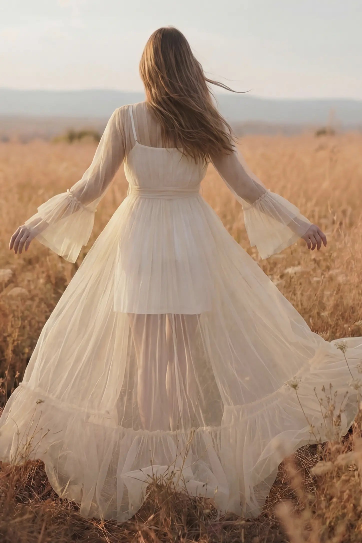 Sheer Tulle Deep V-Neck Tiered Maternity Maxi Gown Sheer tulle deep V-neck tiered maternity maxi gown in Ivory with cascading sheer tulle layers, back view on pregnant model