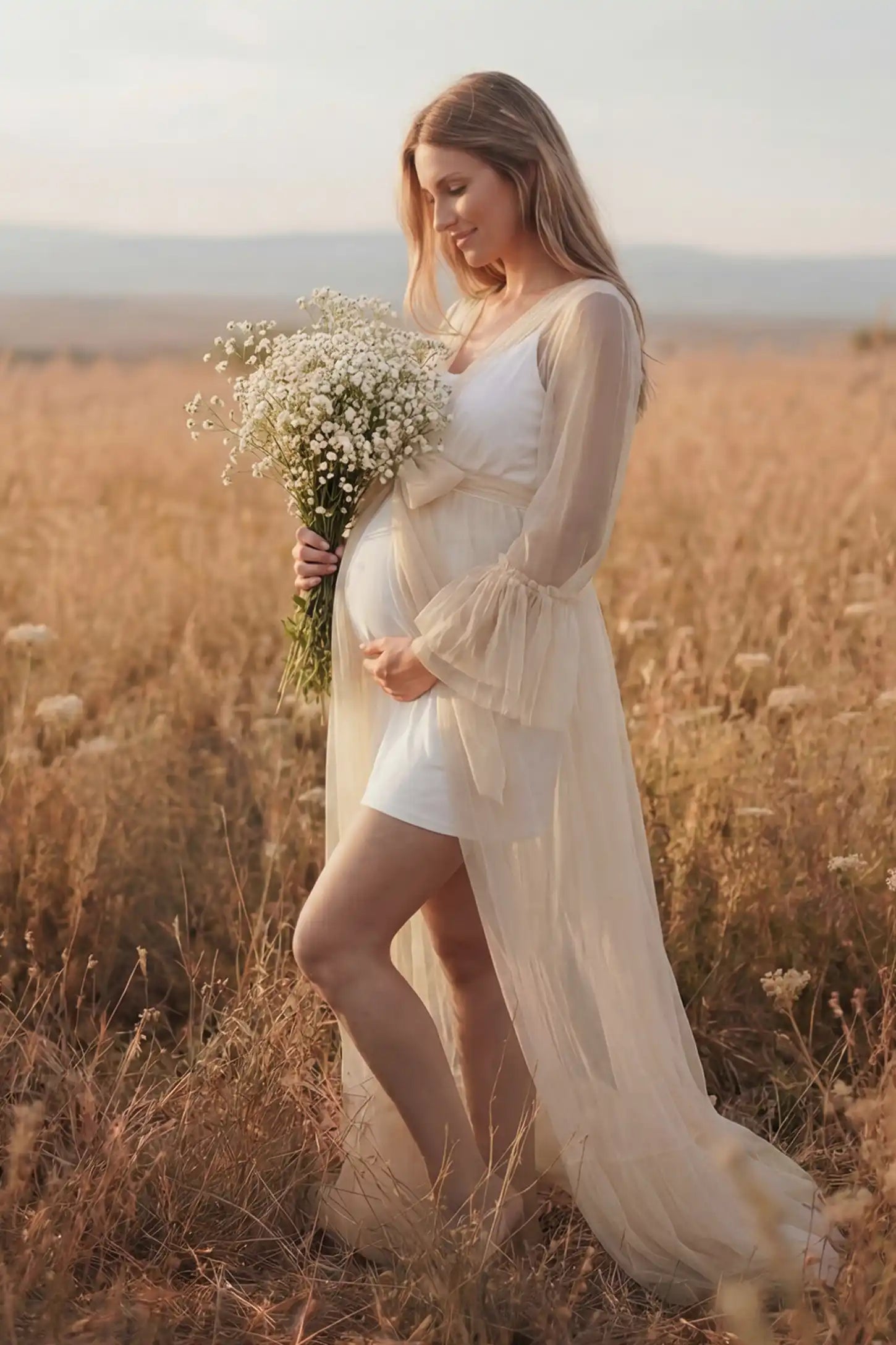 Sheer Tulle Deep V-Neck Tiered Maternity Maxi Gown Sheer tulle deep V-neck tiered maternity maxi gown in Ivory with bump-enhancing layered tulle design, side view on pregnant model