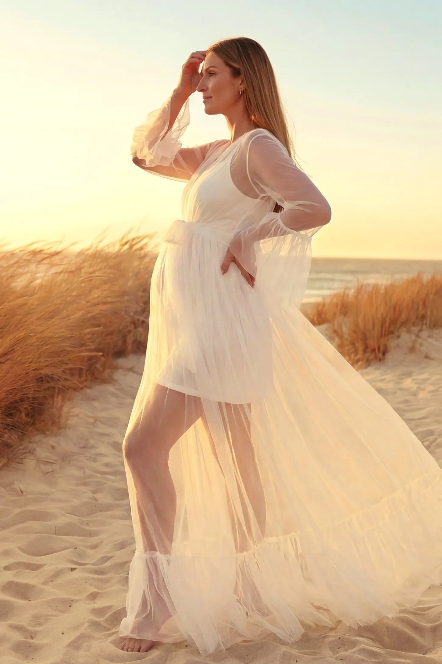Sheer Tulle Deep V-Neck Tiered Maternity Maxi Gown Sheer tulle deep V-neck tiered maternity maxi gown in white with bump-enhancing layered tulle design, side view on pregnant model