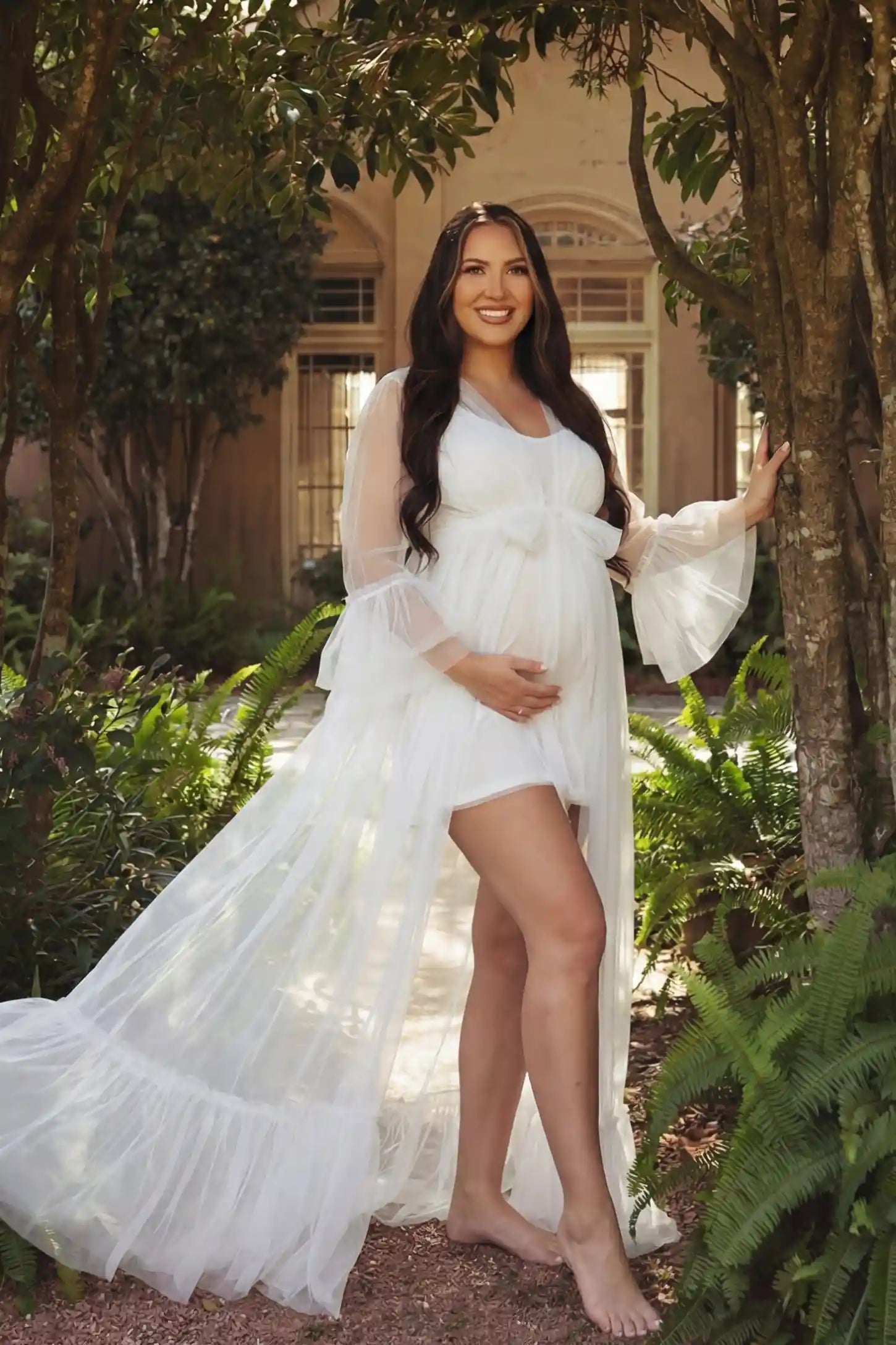 Sheer Tulle Deep V-Neck Tiered Maternity Maxi Gown Sheer tulle deep V-neck tiered maternity maxi gown in white with elegant maternity photoshoot styling, UGC view