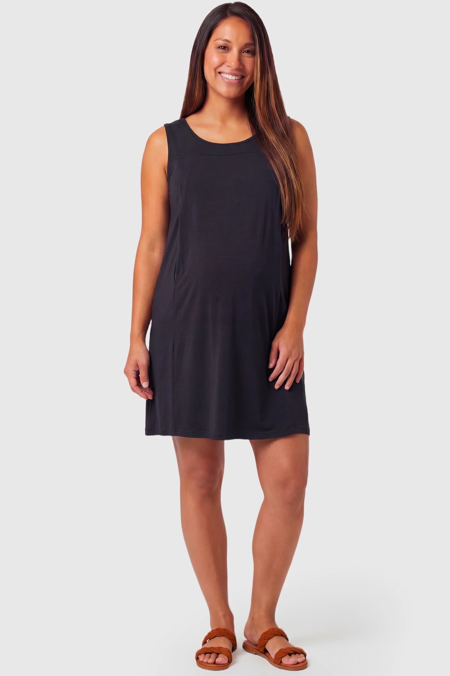 Sleeveless Shift Maternity & Nursing Short Dress Sleeveless Shift Maternity & Nursing Short Dress in black featuring a relaxed shift silhouette and crew neck on a pregnant model.