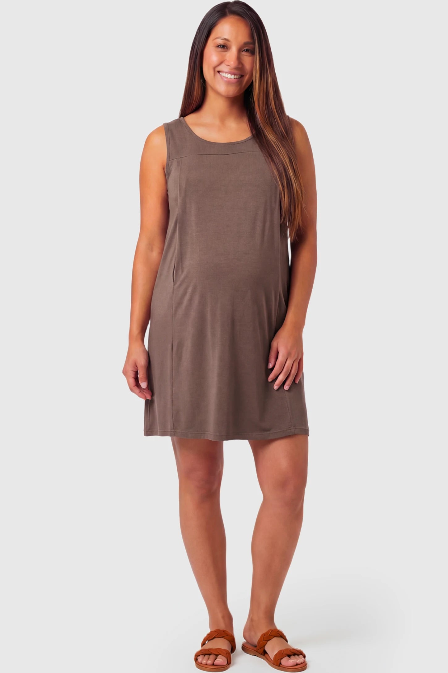 Sleeveless Shift Maternity & Nursing Short Dress Sleeveless Shift Maternity & Nursing Short Dress in brown featuring a relaxed shift silhouette and crew neck on a pregnant model.