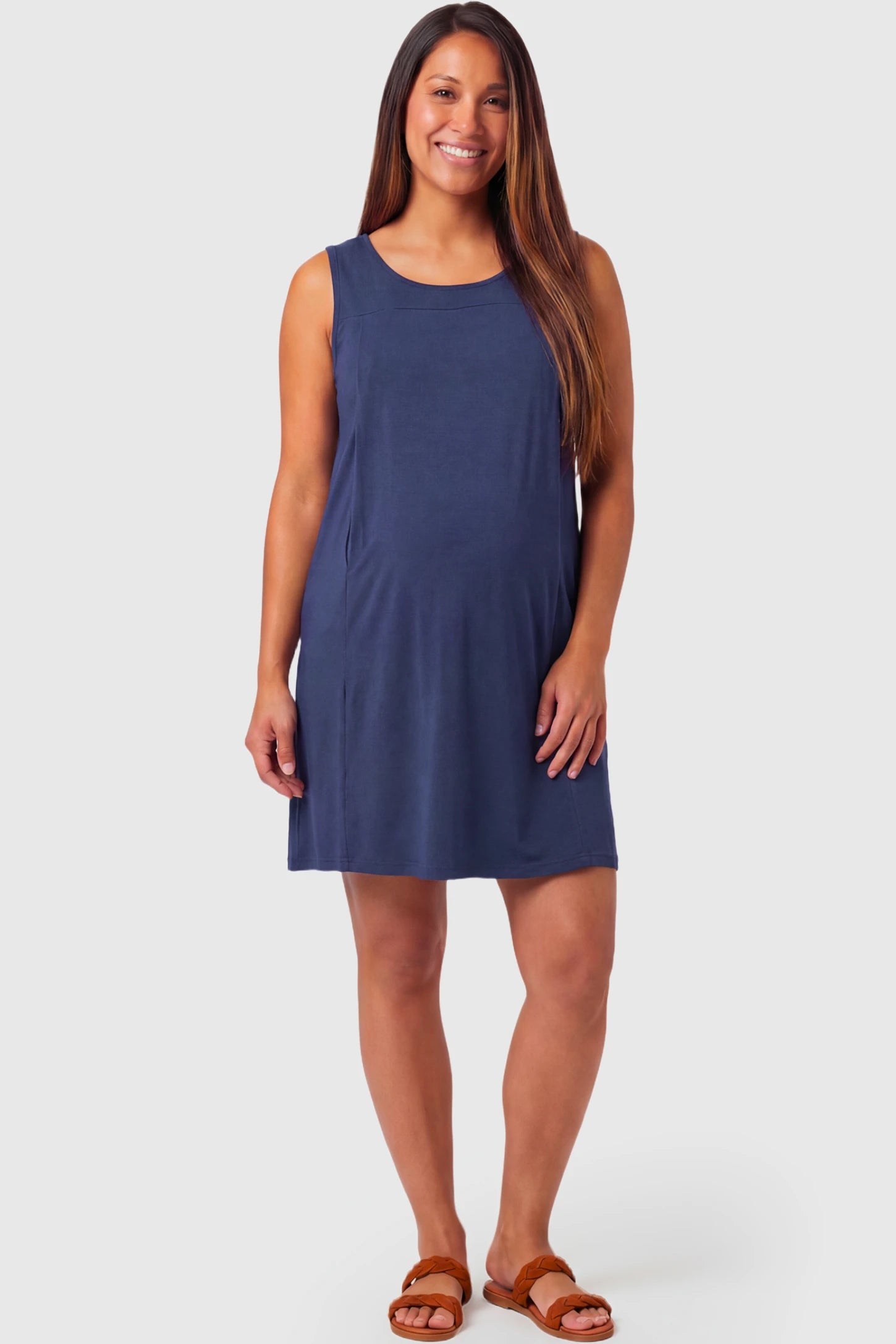 Sleeveless Shift Maternity & Nursing Short Dress Sleeveless Shift Maternity & Nursing Short Dress in navy blue featuring a relaxed shift silhouette and crew neck on a pregnant model.