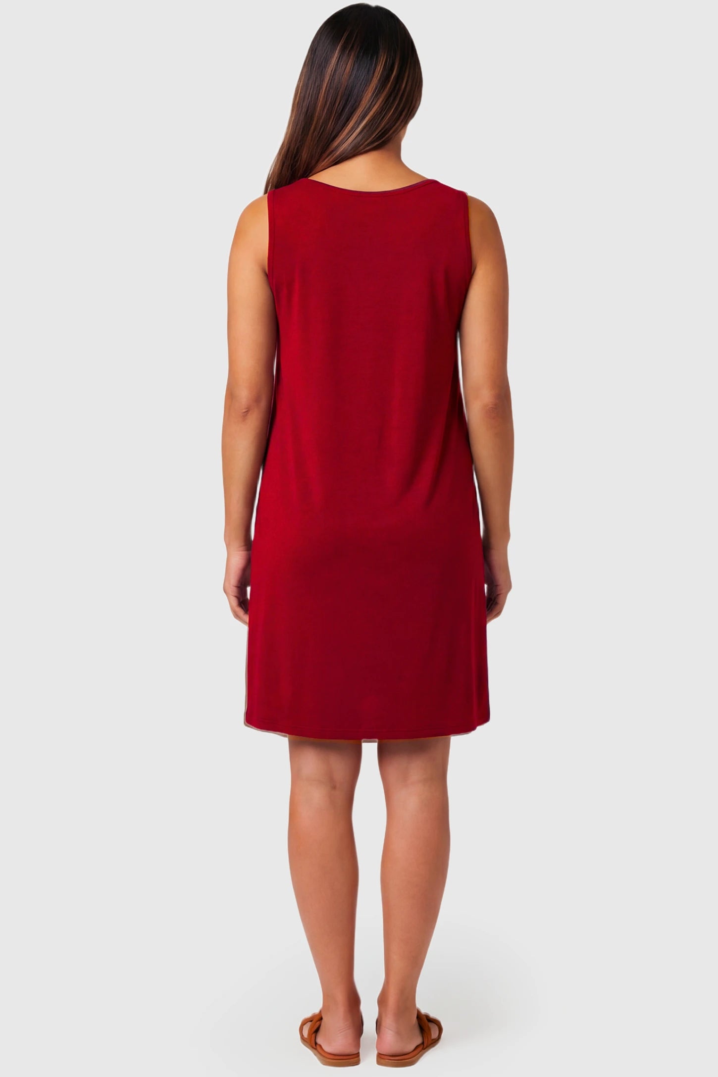Sleeveless Shift Maternity & Nursing Short Dress Sleeveless Shift Maternity & Nursing Short Dress in red featuring a relaxed shift silhouette on a pregnant model.