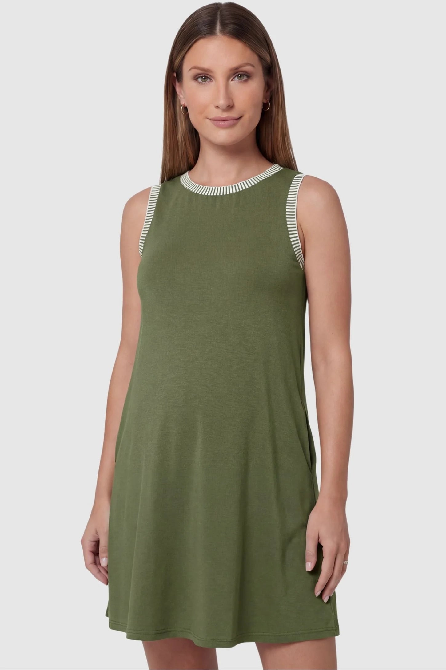 Sleeveless round neck A-line short maternity dress in army green featuring sleeveless and flattering A-line cut in front view on a pregnant model