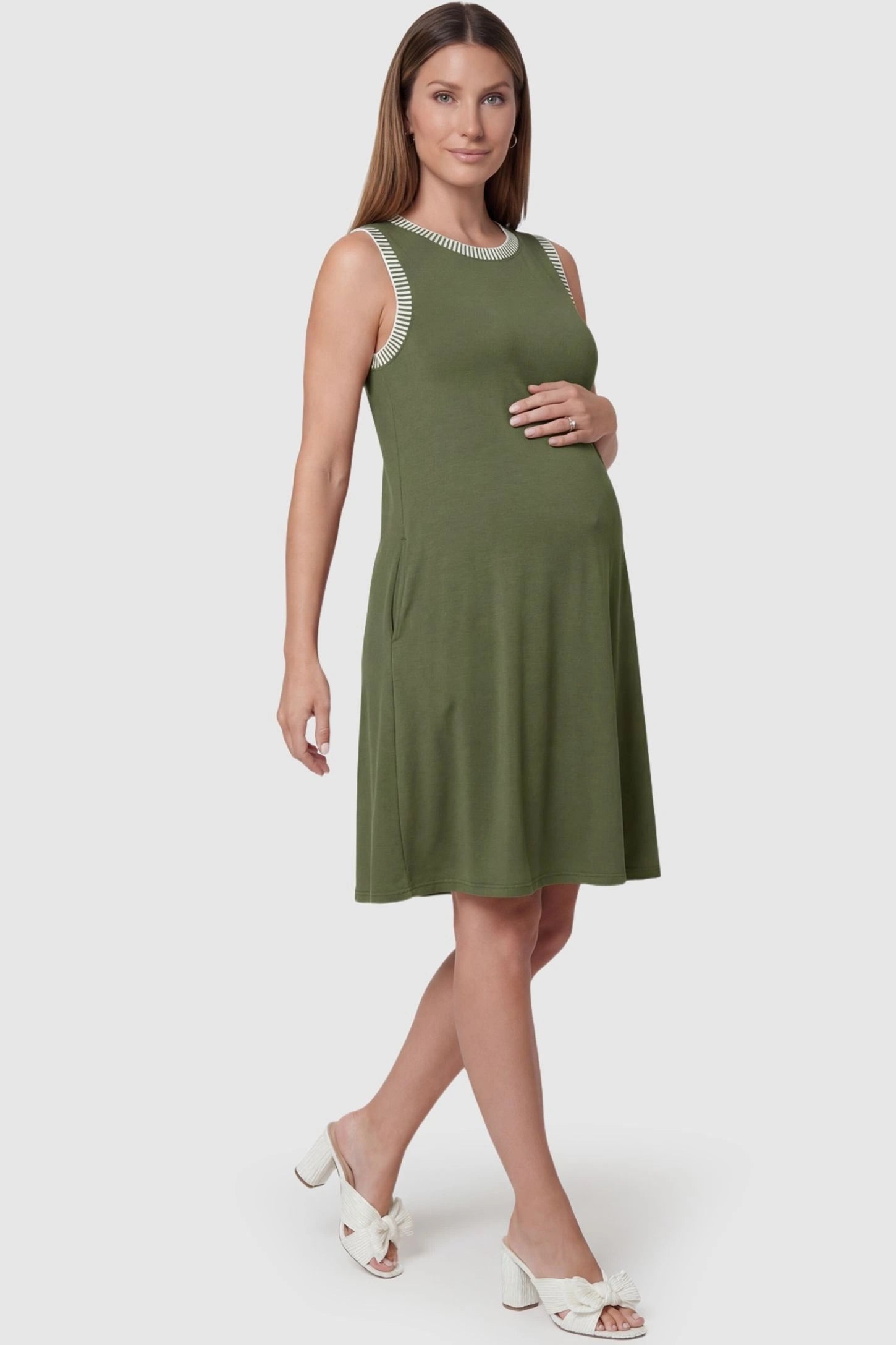Sleeveless Round Neck A-Line Short Maternity Dress Sleeveless round neck A-line short maternity dress in army green featuring umbrella skirt silhouette in full body view on a pregnant model