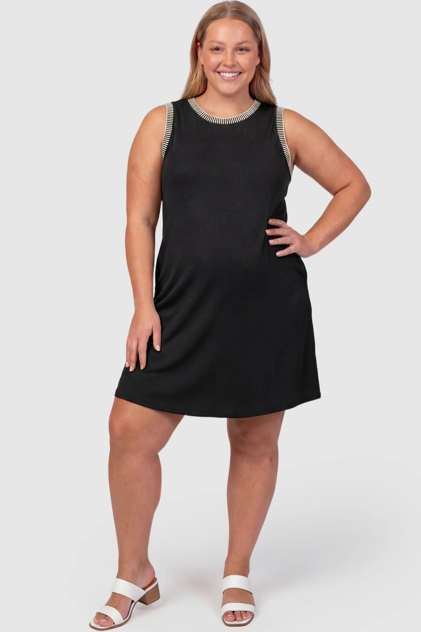 Sleeveless Round Neck A-Line Short Maternity Dress Sleeveless round neck A-line short maternity dress in black featuring umbrella skirt silhouette in full body view on a plus-size model