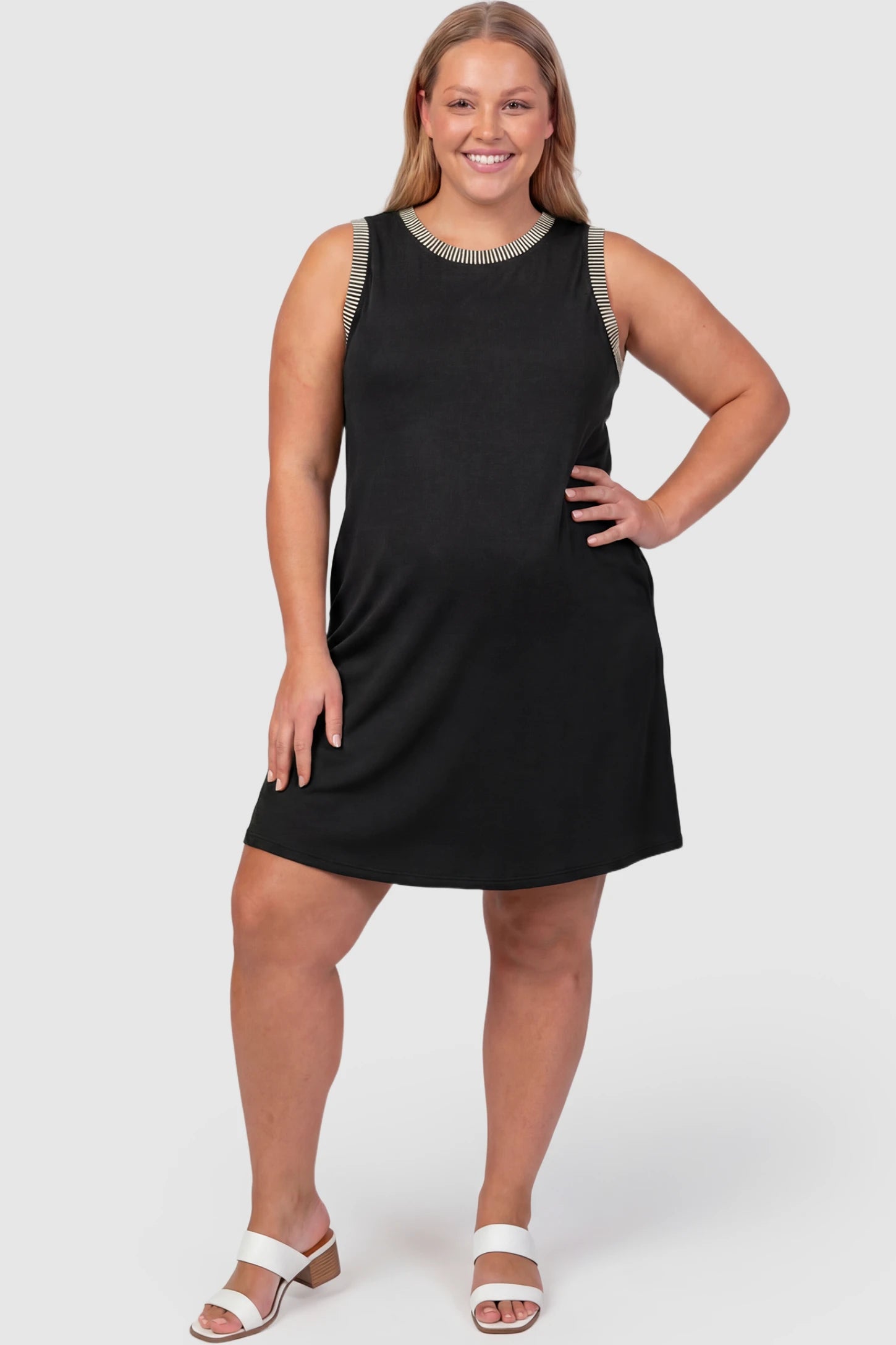 Sleeveless A-Line Maternity Mini Dress Sleeveless A-Line Maternity Short Dress in black featuring sleeveless cut in front view on a plus-size model