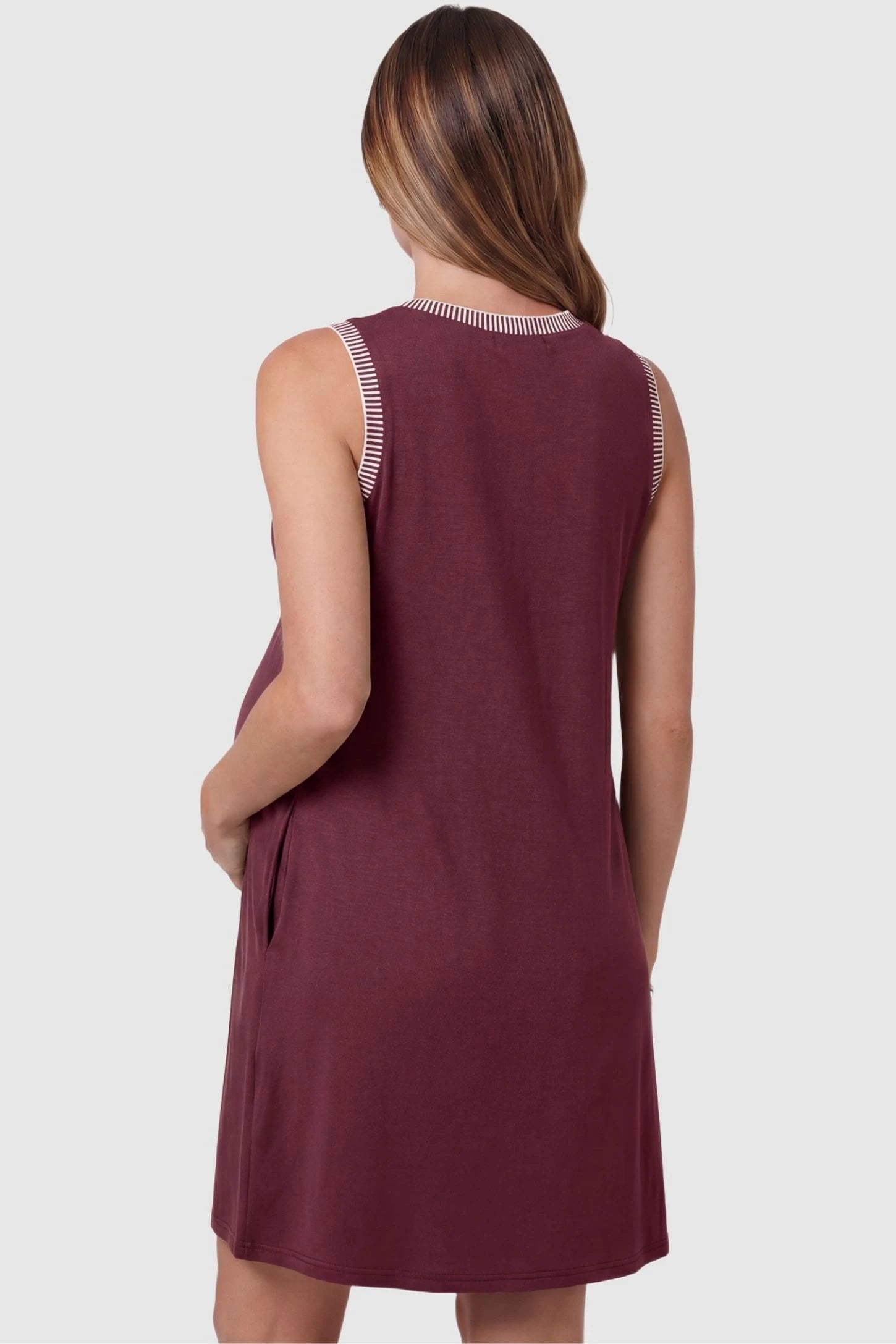 Sleeveless Round Neck A-Line Short Maternity Dress Sleeveless round neck A-line short maternity dress in burgundy featuring clean back design in back view on a pregnant model