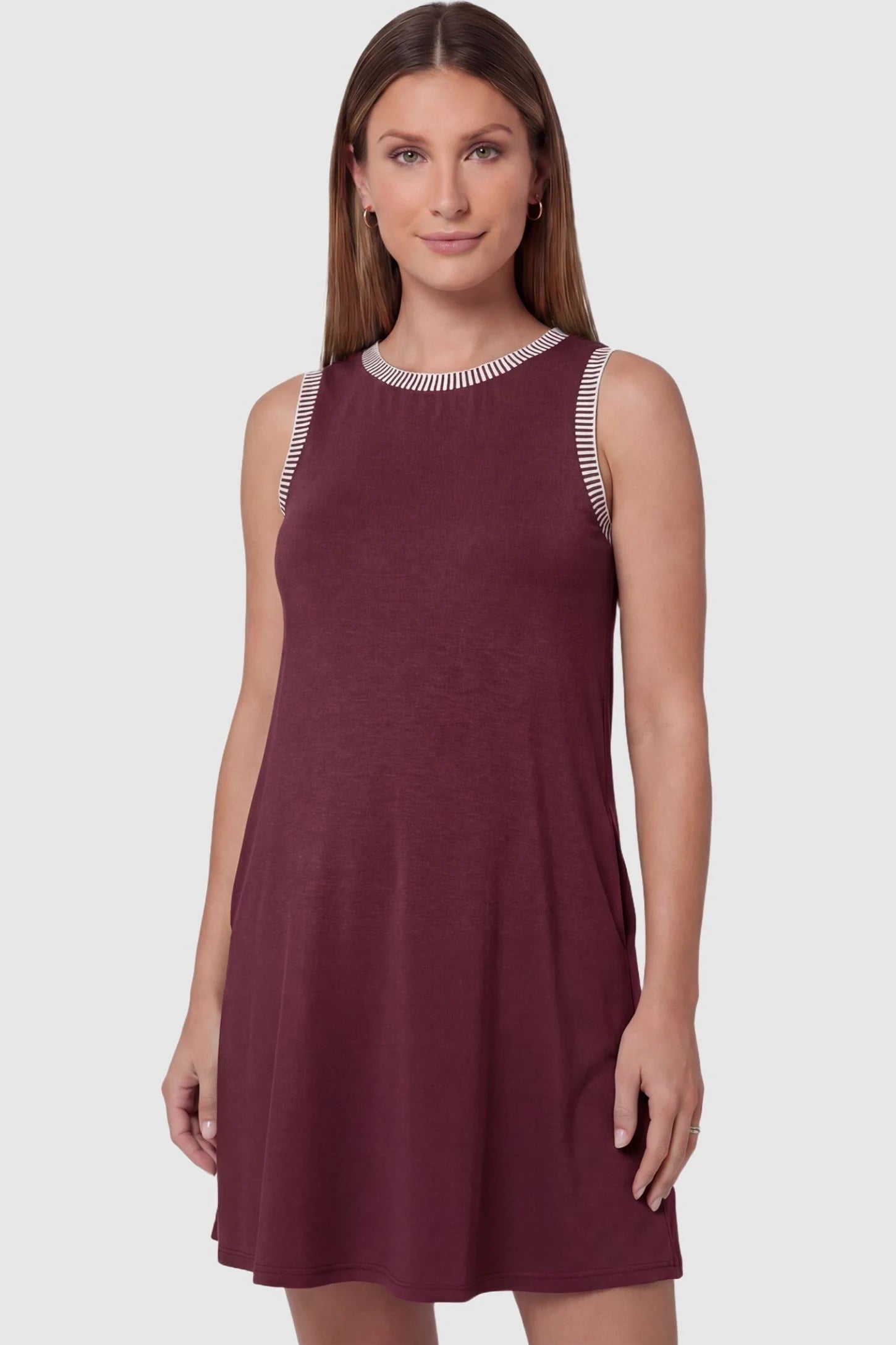 Sleeveless Round Neck A-Line Short Maternity Dress Sleeveless round neck A-line short maternity dress in burgundy featuring sleeveless and flattering A-line cut in front view on a pregnant model