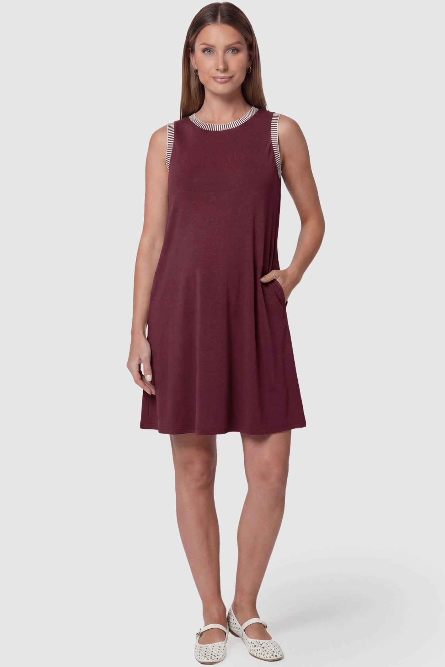 Sleeveless Round Neck A-Line Short Maternity Dress Sleeveless round neck A-line short maternity dress in burgundy featuring sleeveless and flattering A-line cut in front view on a pregnant model