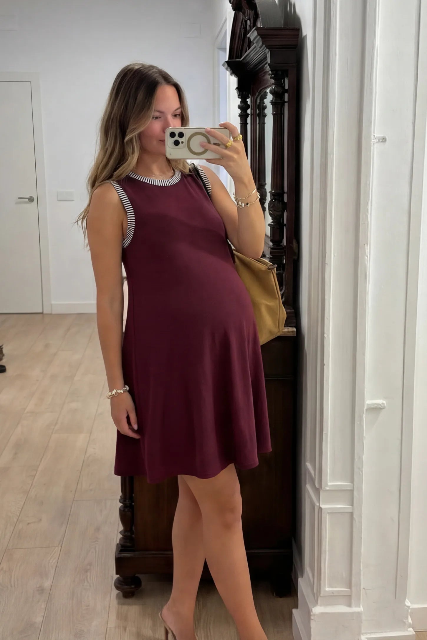 Sleeveless A-Line Maternity Mini Dress Sleeveless A-Line Maternity Short Dress in burgundy featuring sleeveless cut in front view on a pregnant model