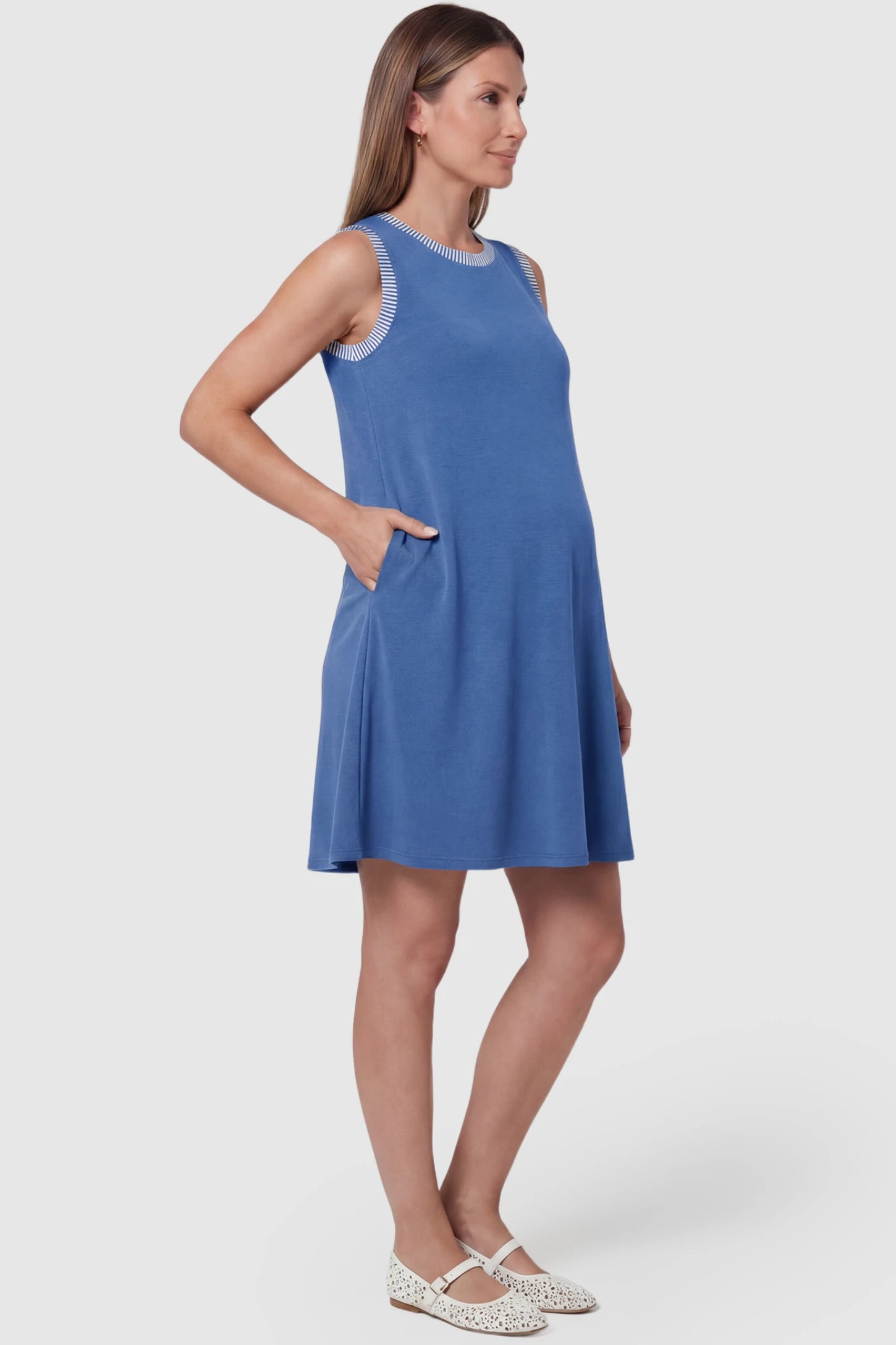 Sleeveless A-Line Maternity Mini Dress Sleeveless A-Line Maternity Short Dress in royal blue featuring sleeveless cut in side view on a pregnant model