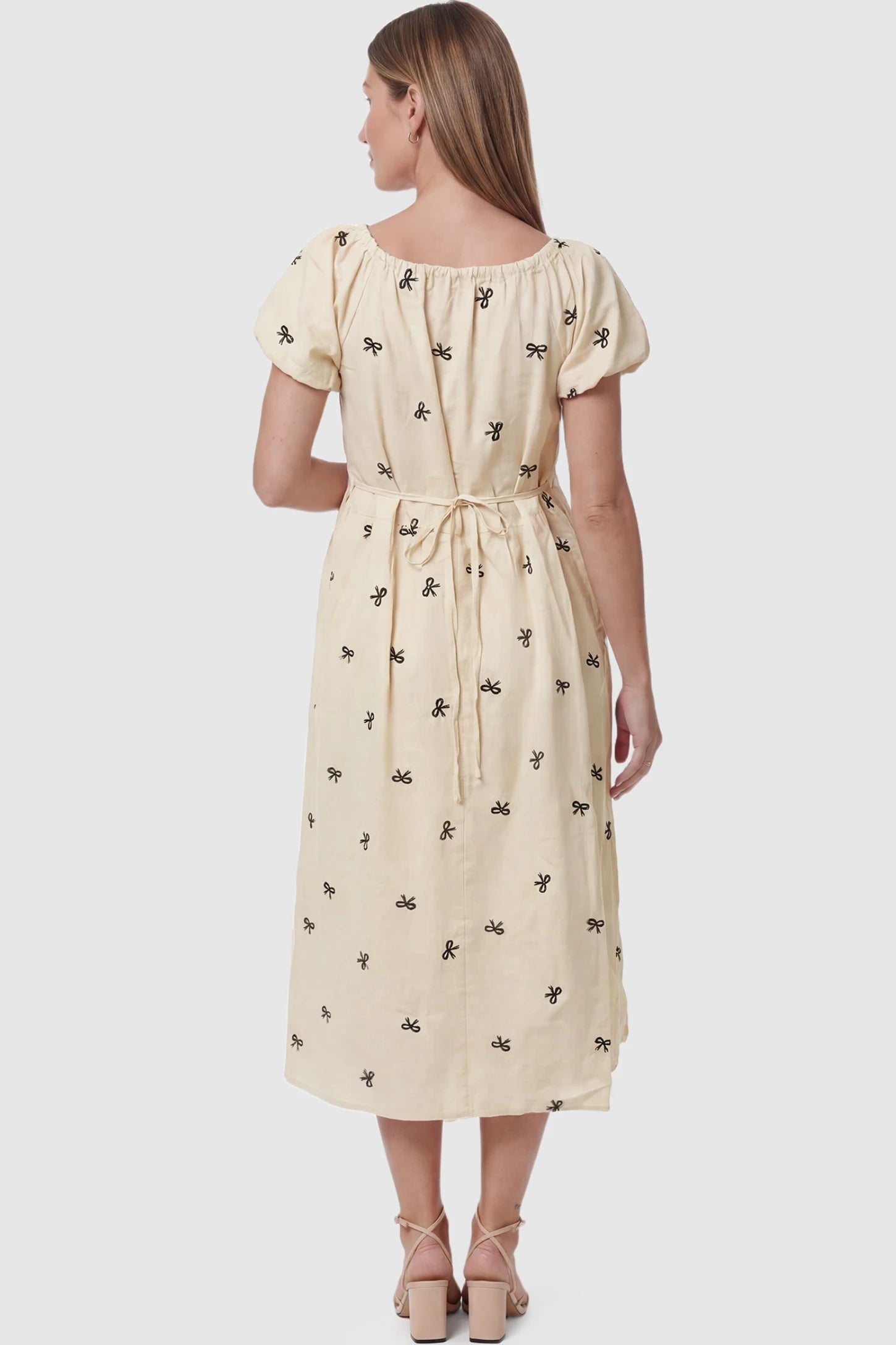 Bow Print Drawstring Neck Maternity Midi Dress Bow print drawstring neck maternity midi dress in beige with comfortable adjustable waist, back view on pregnant model