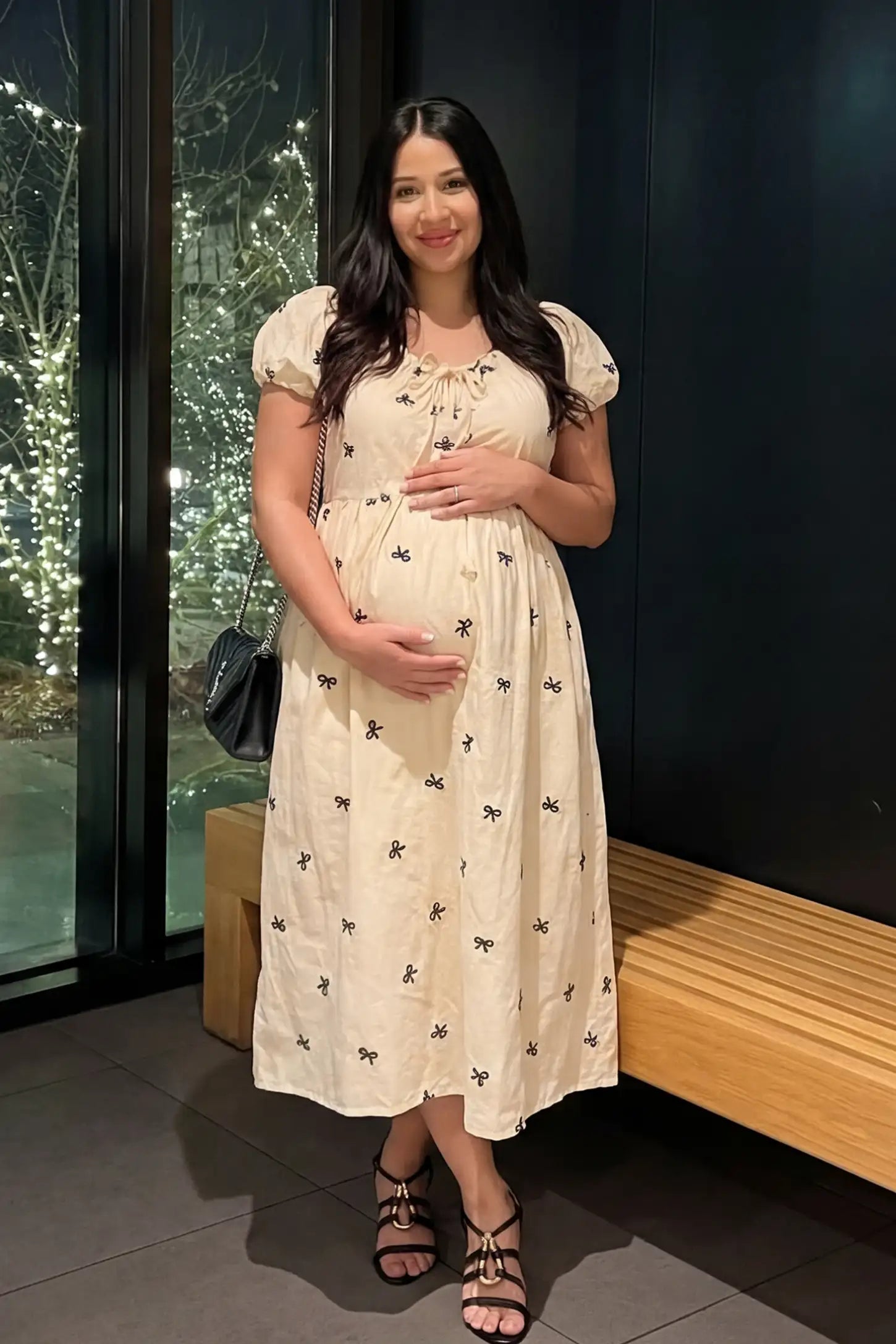 Bow Print Drawstring Neck Maternity Midi Dress Bow print drawstring neck maternity midi dress in beige with drawstring neckline detail, front view on pregnant model
