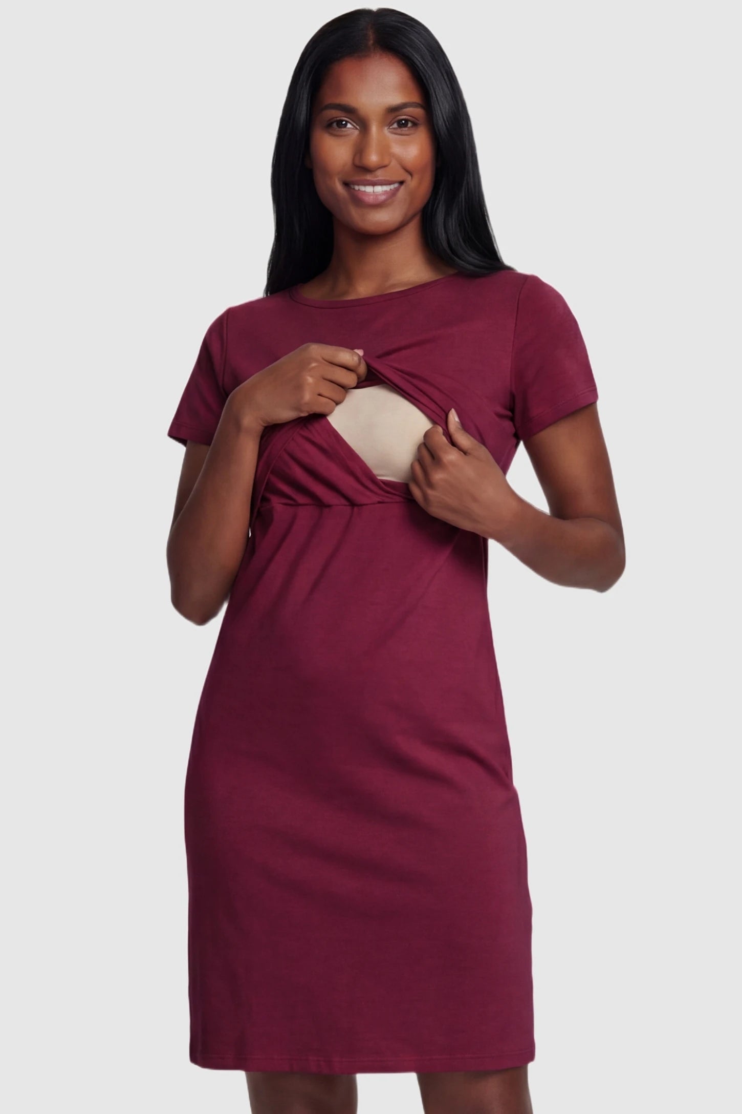 Short Sleeve Layered Midi Maternity Nursing Dress Short Sleeve Layered Midi Maternity Nursing Dress in Burgundy featuring a discreet double-layered nursing opening for breastfeeding on a postpartum model.