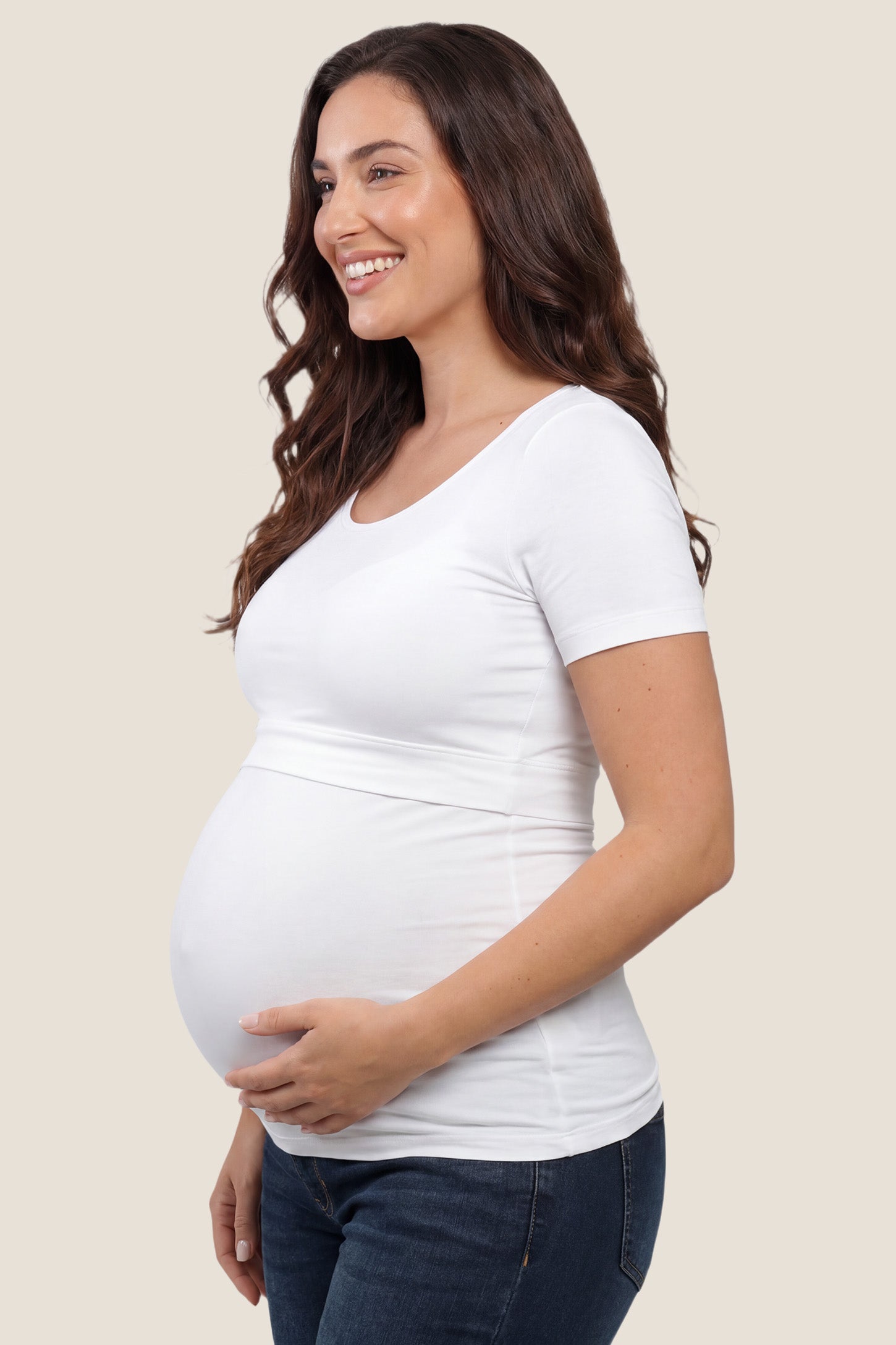 Basic Crew Neck Maternity & Nursing T-Shirt Basic Crew Neck Maternity & Nursing T-Shirt in White featuring a stretch-fit round neck design on a pregnant model, side view.