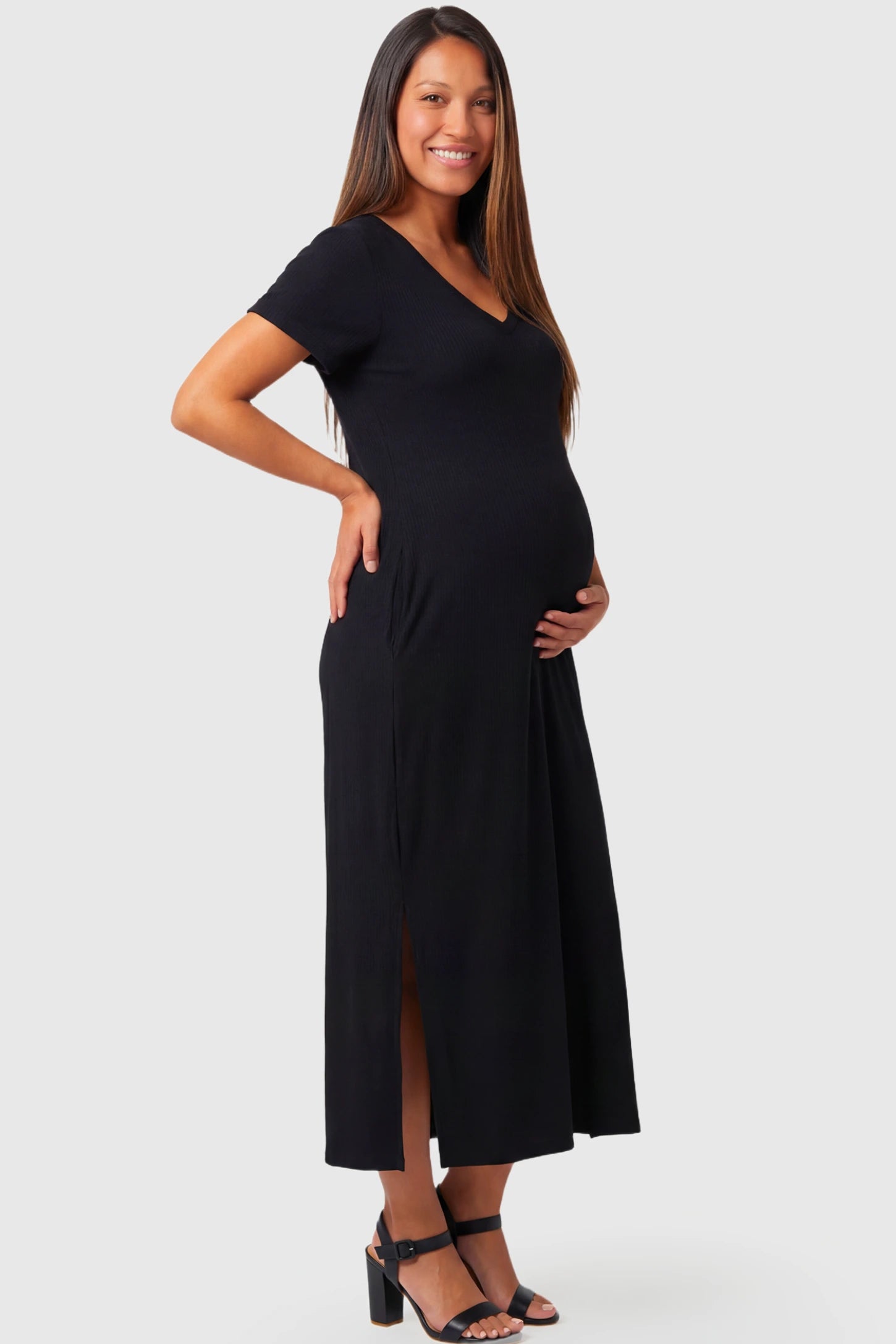 Casual V-Neck Short Sleeve Maternity Midi Dress in black featuring a relaxed straight fit and side slit on a pregnant model.