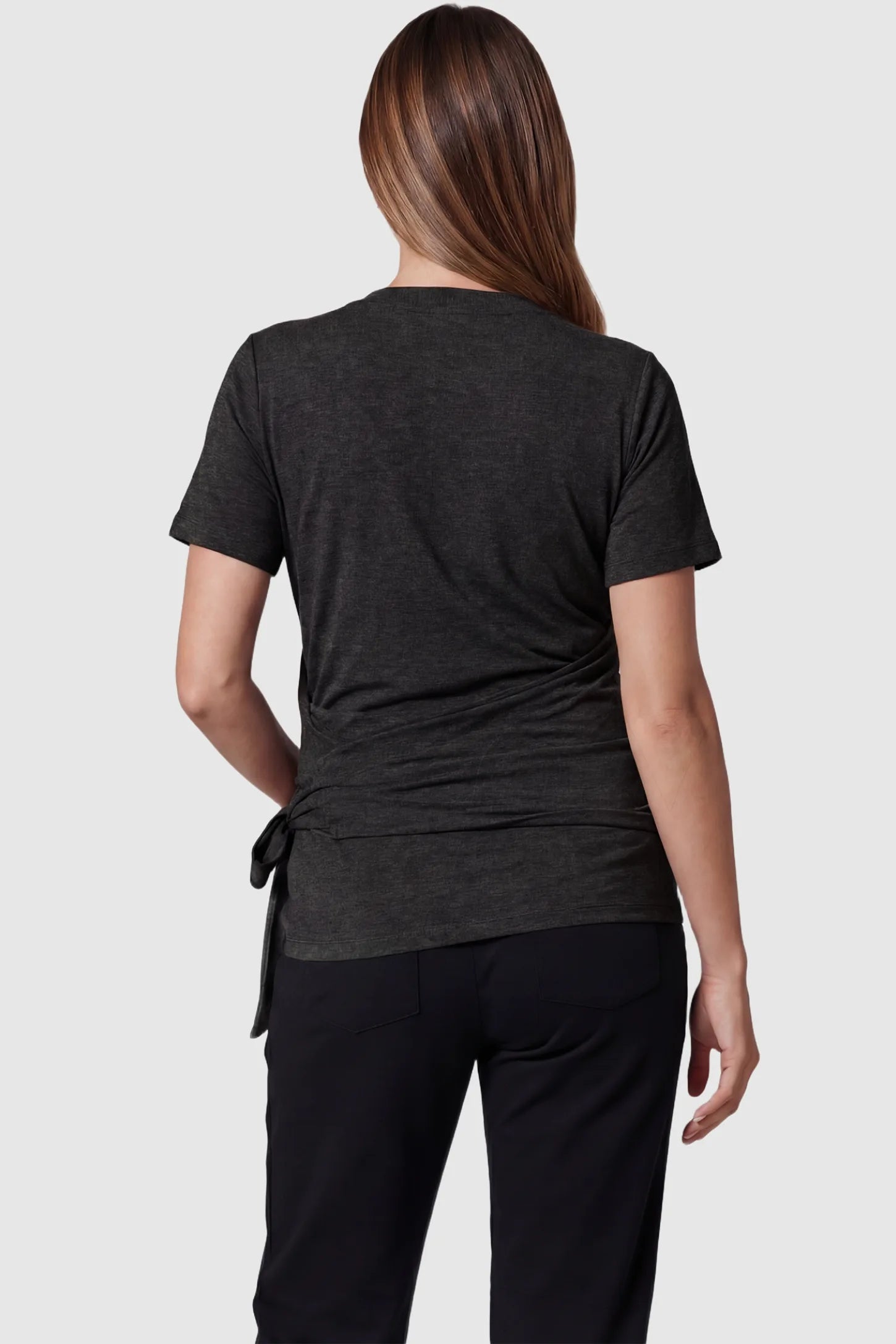 3 in 1 Skin to Skin Wrap Nursing Top Skin to Skin Wrap Nursing Top in black featuring short sleeves on pregnant model, back view.