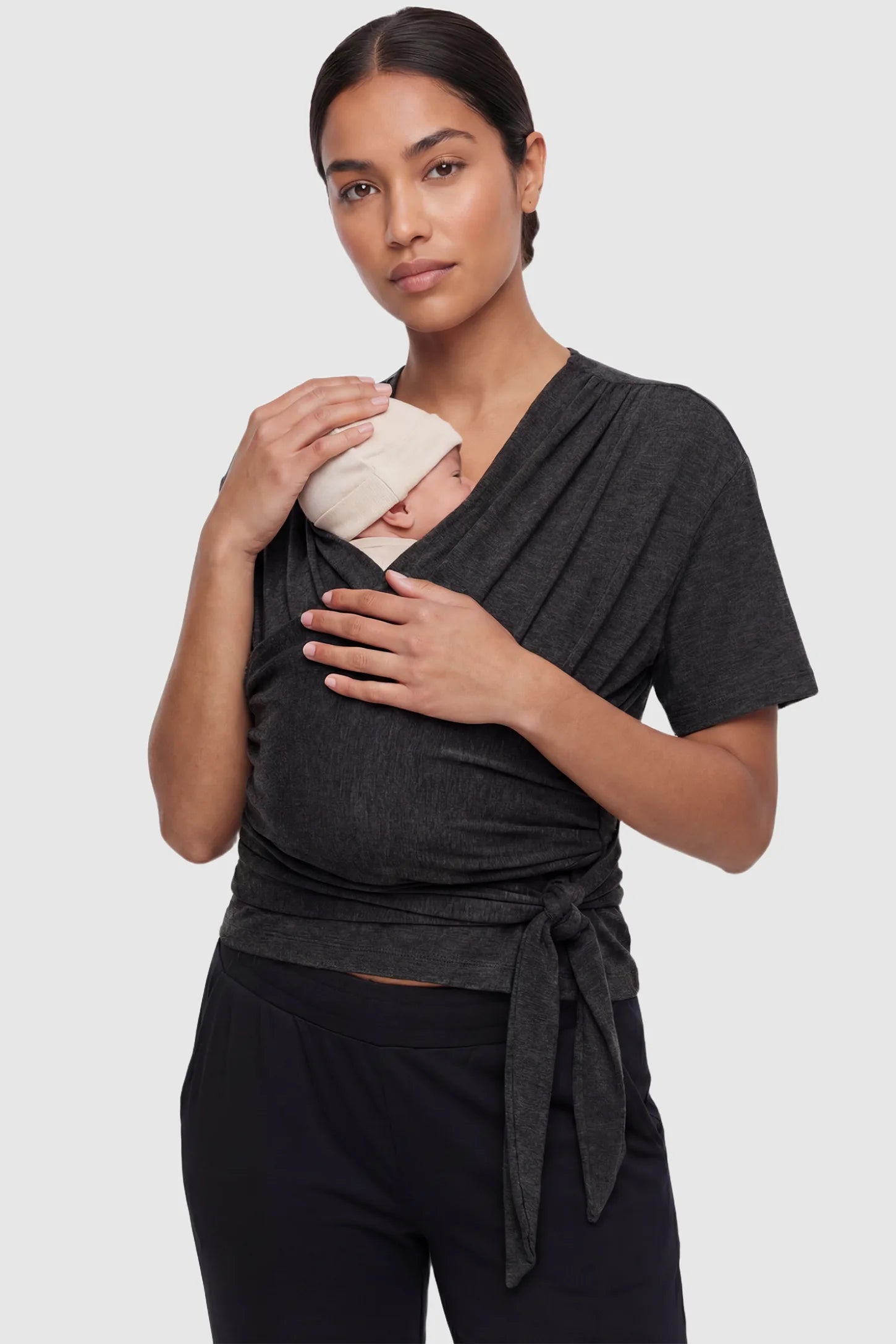 3 in 1 Skin to Skin Wrap Nursing Top Skin to Skin Wrap Nursing Top in black featuring soft wrap-front design and short sleeves on non pregnant model.