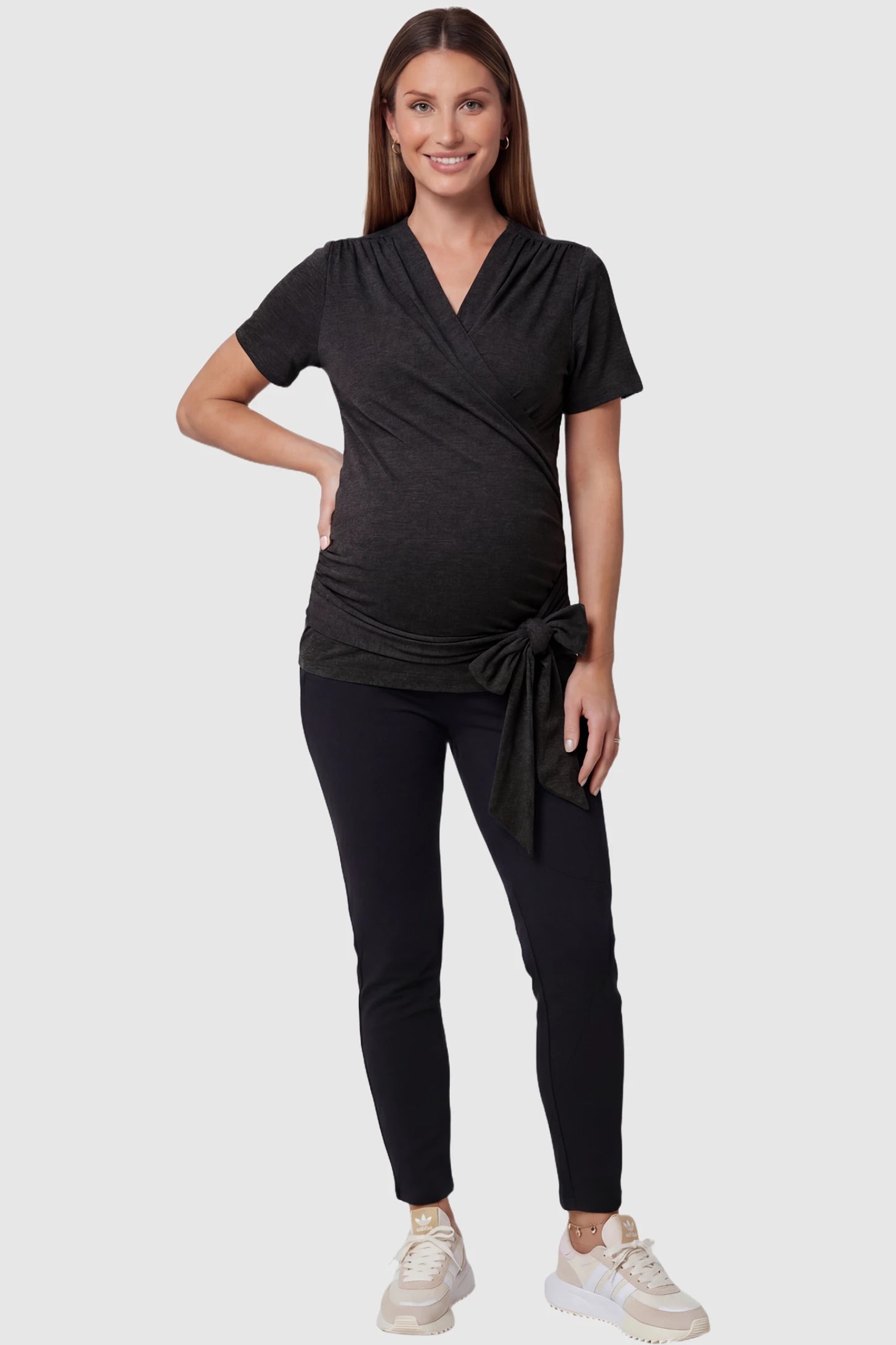 3 in 1 Skin to Skin Wrap Nursing Top Skin to Skin Wrap Nursing Top in black featuring soft wrap-front design and short sleeves on pregnant model, full body