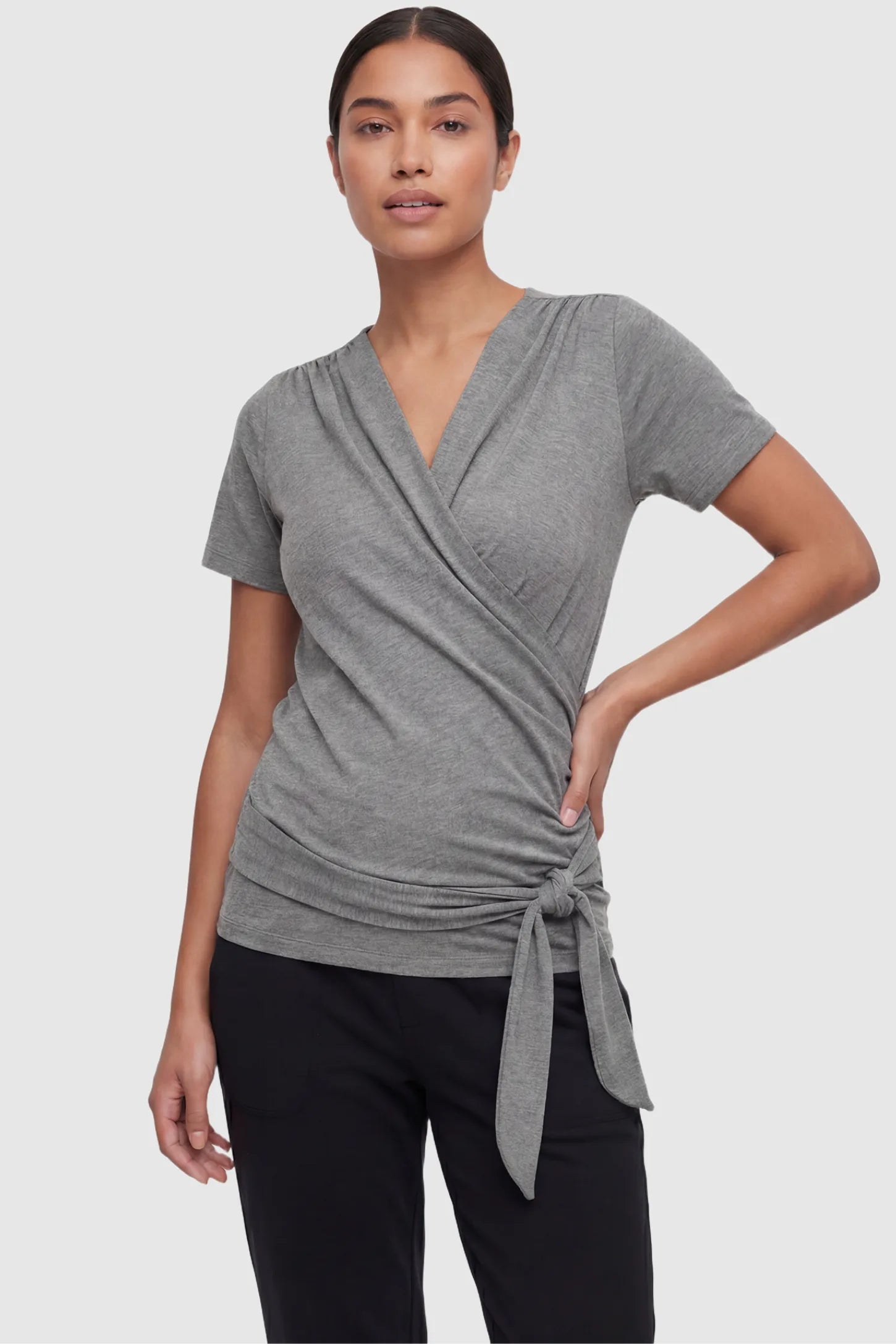 3 in 1 Skin to Skin Wrap Nursing Top Skin to Skin Wrap Nursing Top in gray featuring soft wrap-front design and short sleeves on non pregnant model.