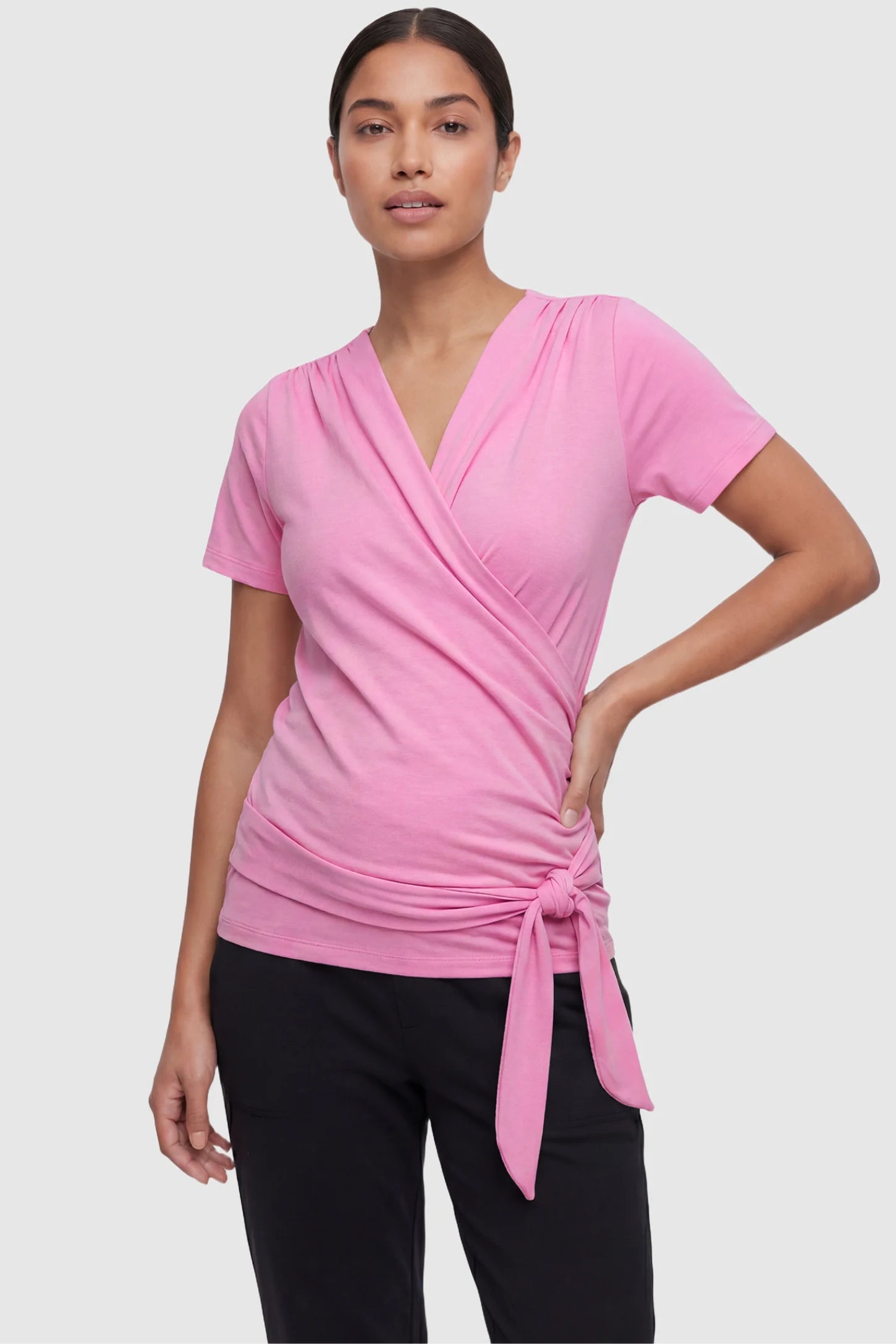 3 in 1 Skin to Skin Wrap Nursing Top Skin to Skin Wrap Nursing Top in pink featuring soft wrap-front design and short sleeves on non pregnant model.