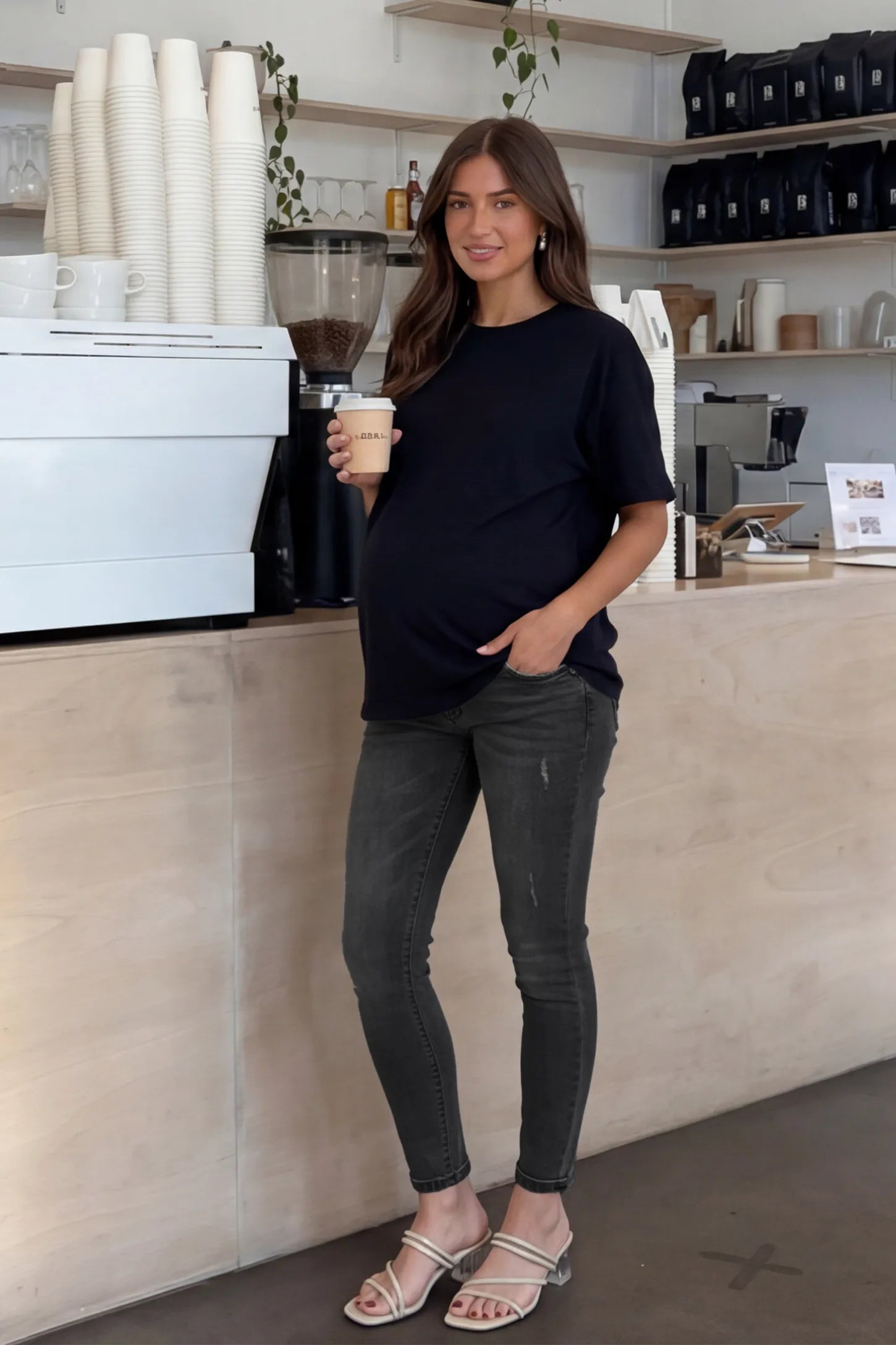 Cuffed Hem Skinny Maternity Jeans Cuffed Hem Skinny Maternity Jeans in black featuring full belly panel and ankle-length cuffed hem on front  view pregnant model.