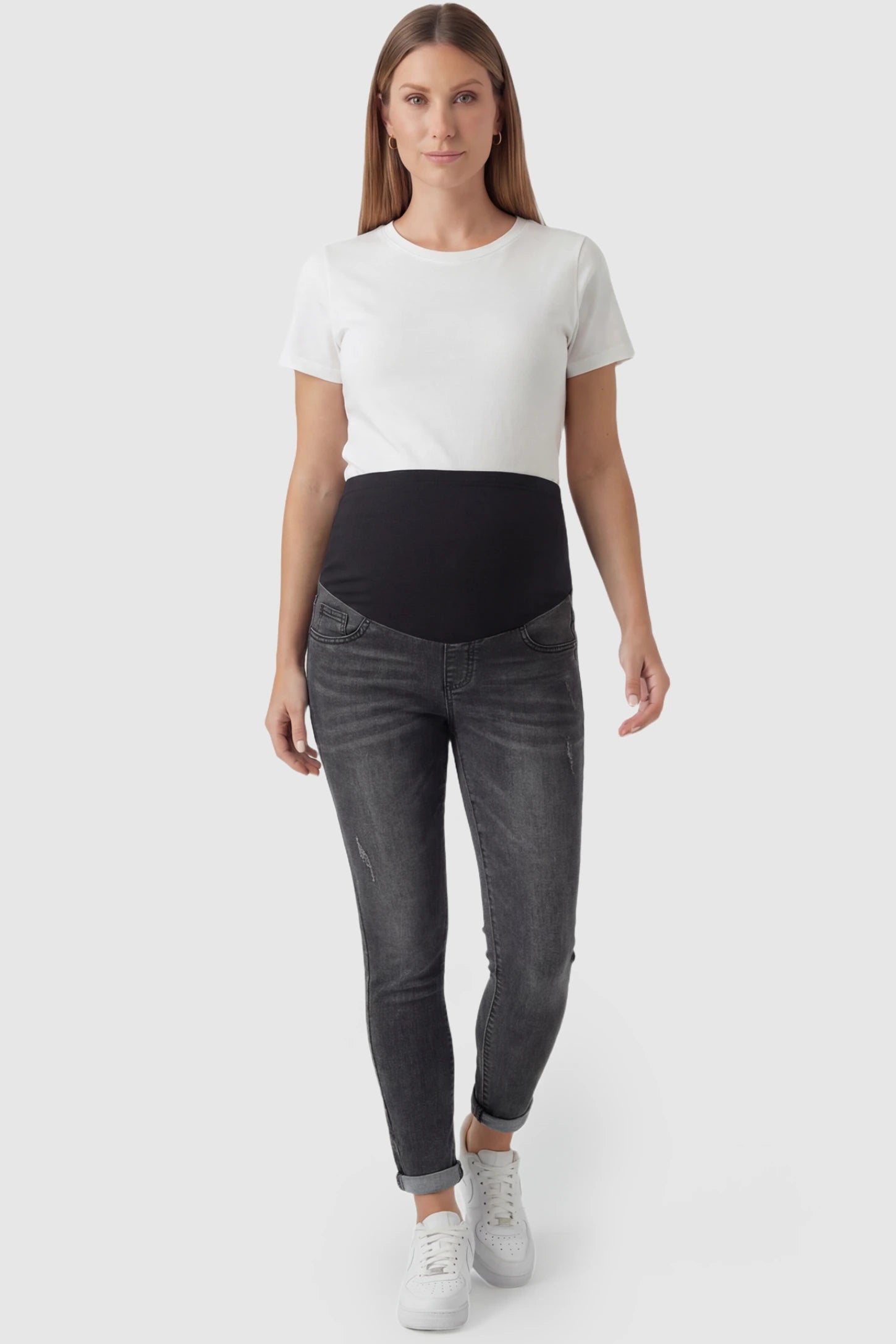 Cuffed Hem Skinny Maternity Jeans Cuffed Hem Skinny Maternity Jeans in black featuring full belly panel and ankle-length cuffed hem on pregnant model.